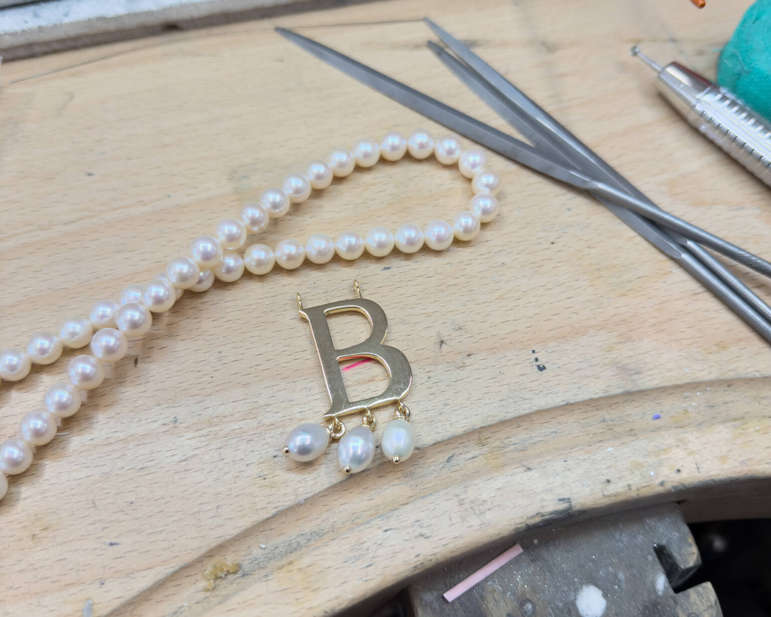 Anne Boleyn 'B' necklace crafted by hand in Cassandra Goad's London workshop.