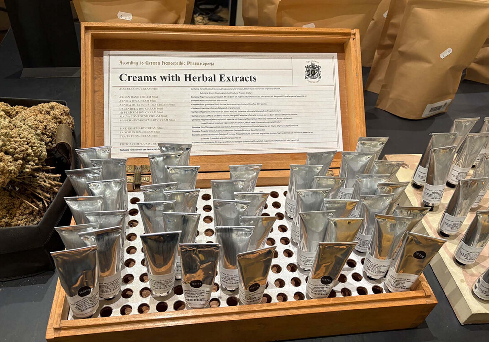Wooden box filled with different Naxos Apothecary herbal creams.