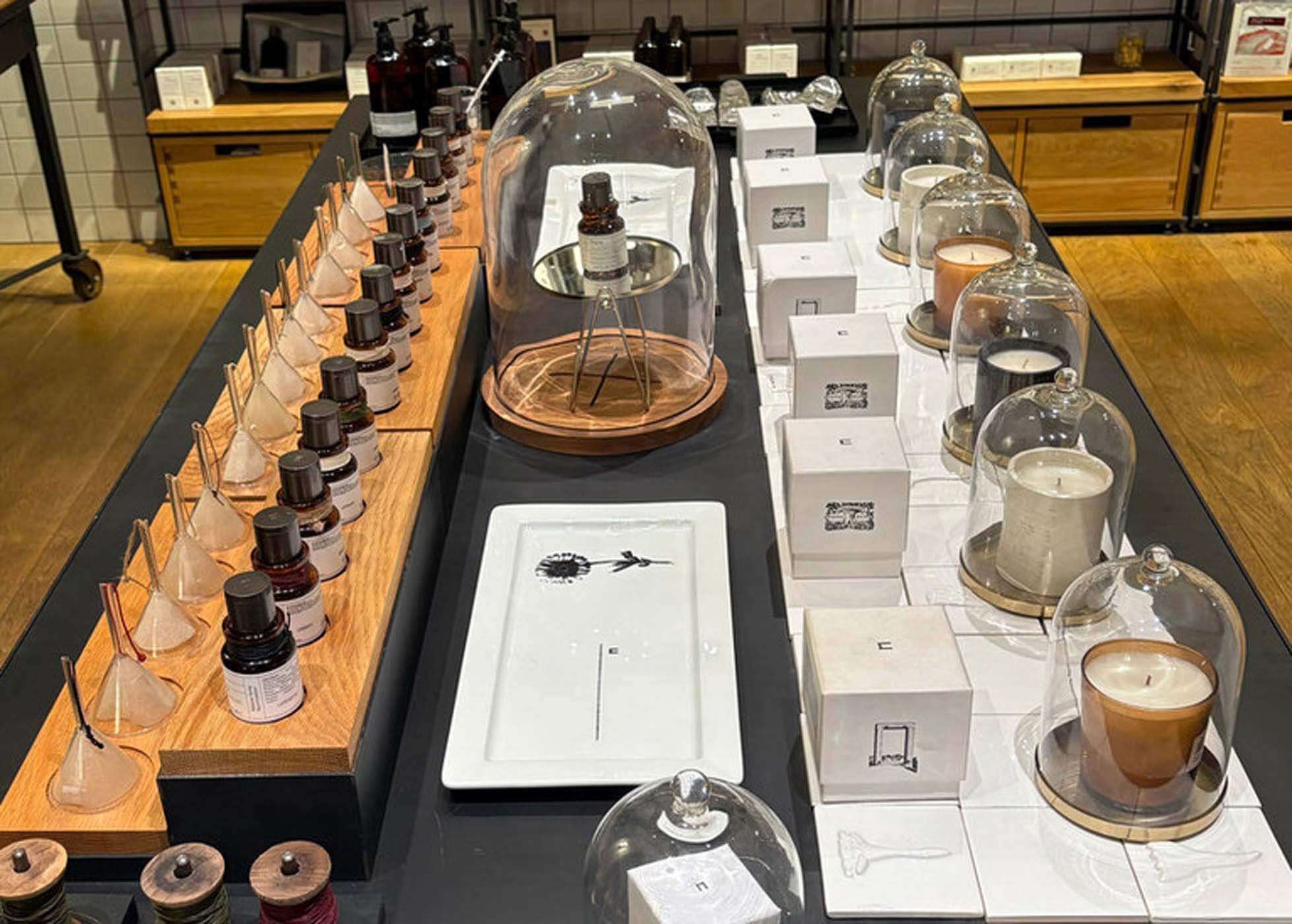 Display of perfumes and scented candles inside Naxos Apothecary boutique in Athens.
