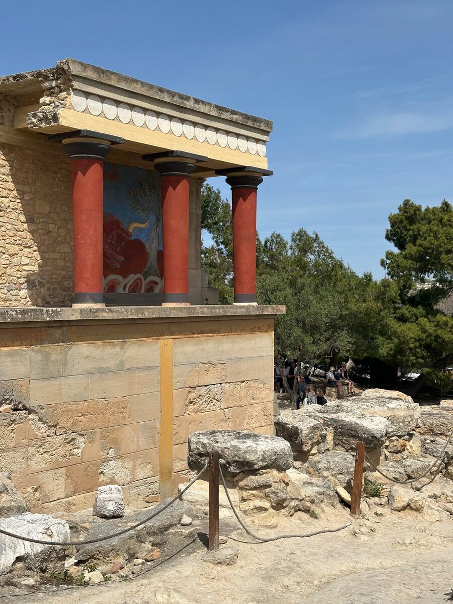 Palace of Knossos exterior with iconic red columns.
