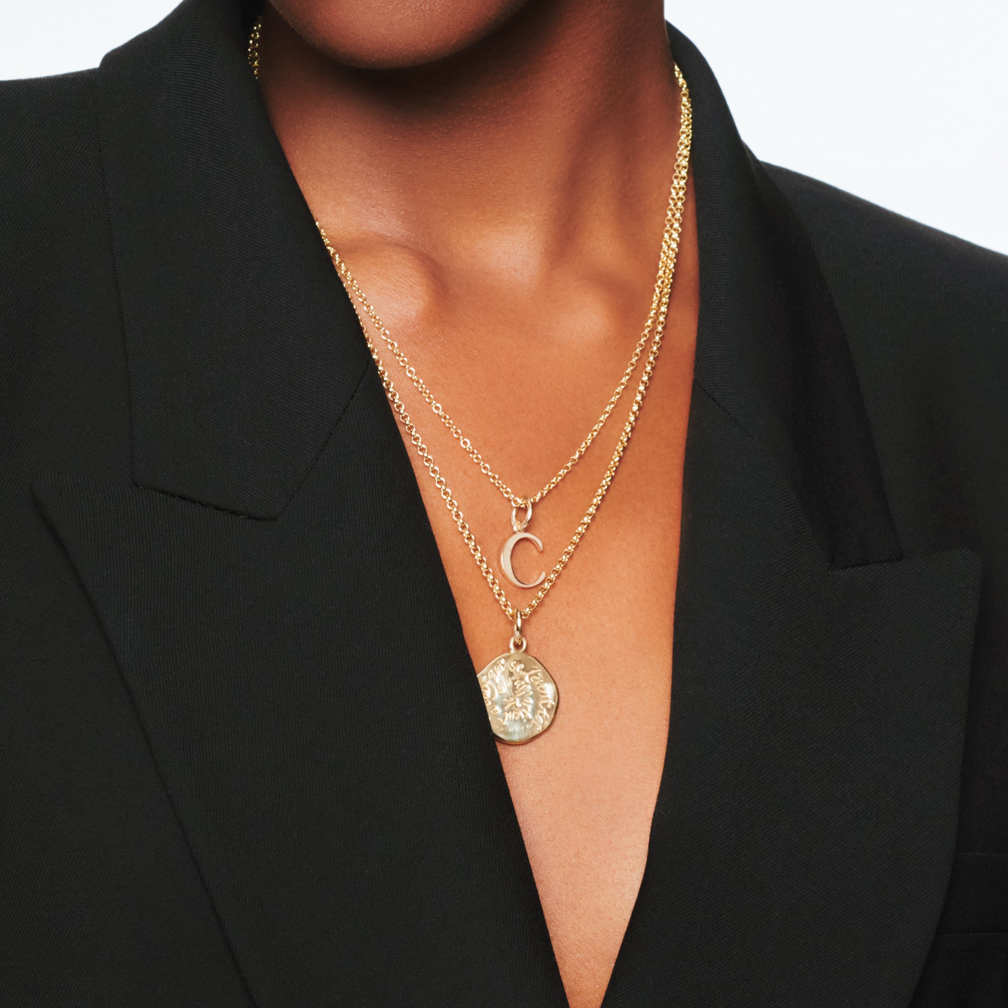 Handcrafted round yellow gold necklace pendant engraved with a quote.