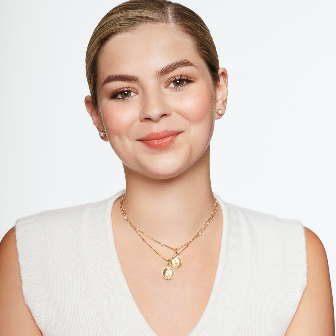 Model wearing a handcrafted yellow gold necklace pendant 'en relief' with culture from France.