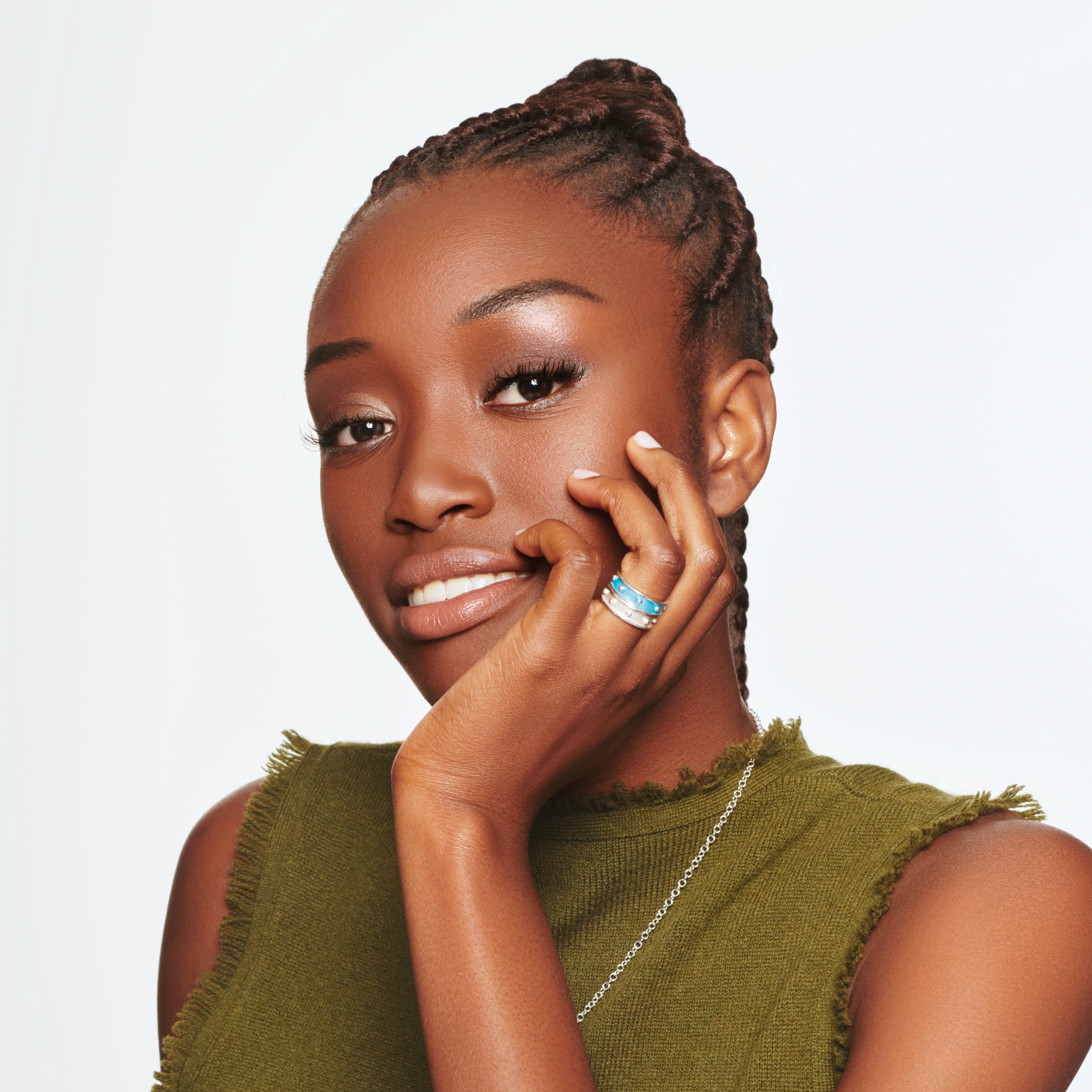 Model wearing handcrafted yellow gold rings with evenly spaced, protruding round dots with diamonds.