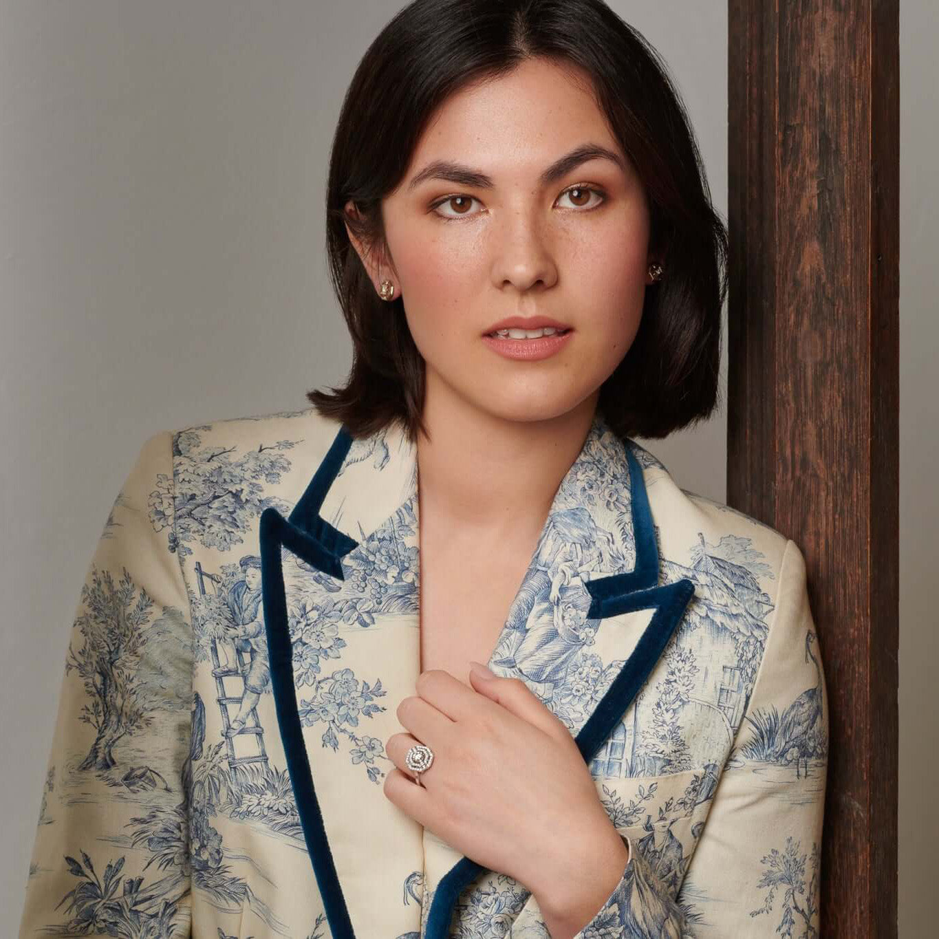 A woman holding her hand up to showcase an 18ct white gold engagement ring set with diamonds.