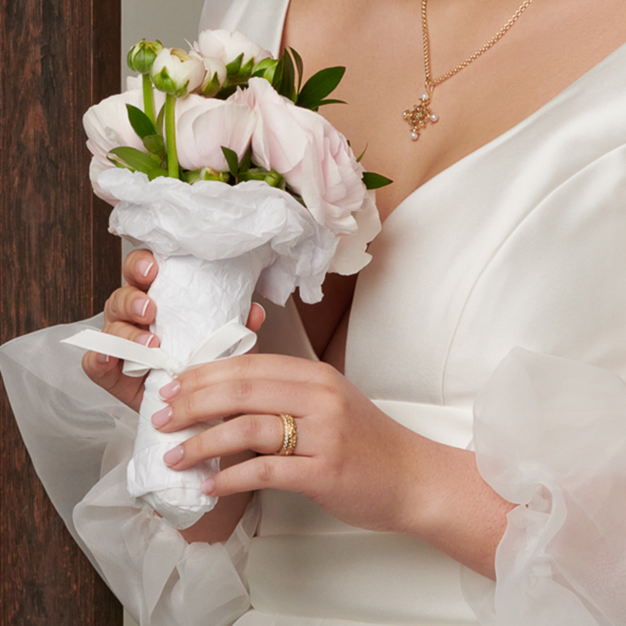 Model wearing a handcrafted yellow gold ring featuring the plum blossoms in Japan.