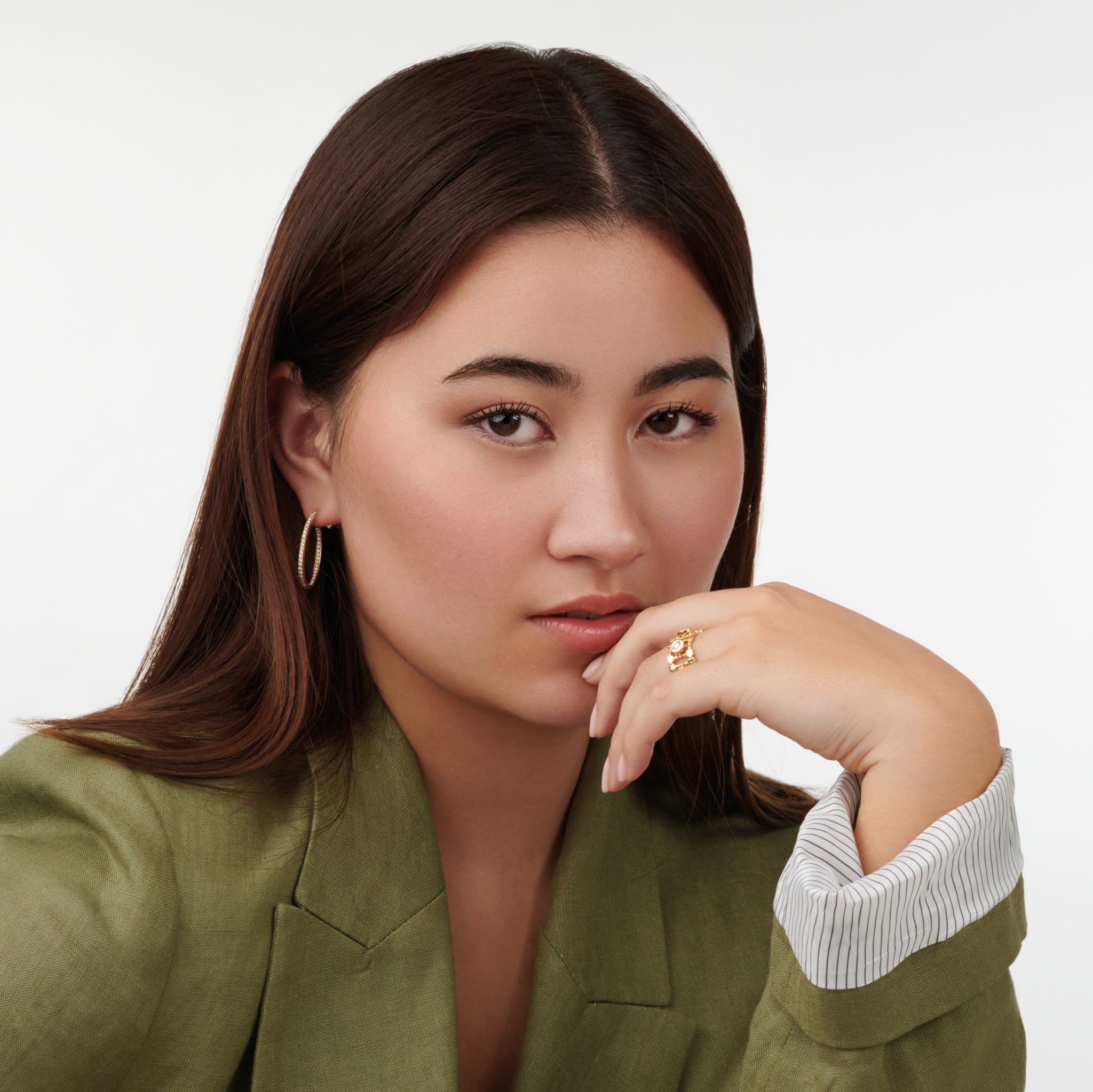 Model wearing a handcrafted 18ct yellow gold ring featuring a trellis shaped frame with diamonds.