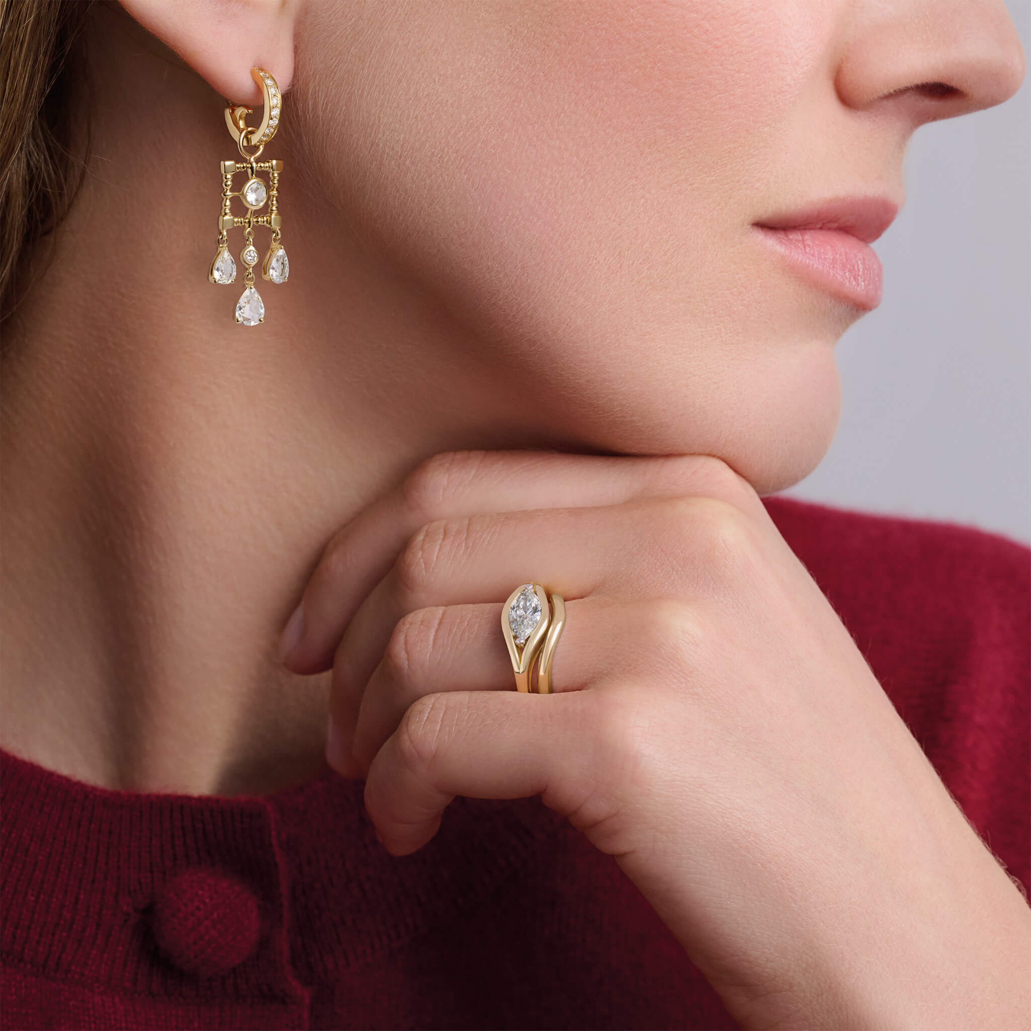 Model wears handcrafted Marielle engagement ring in 18ct yellow and white gold with central marquise diamond