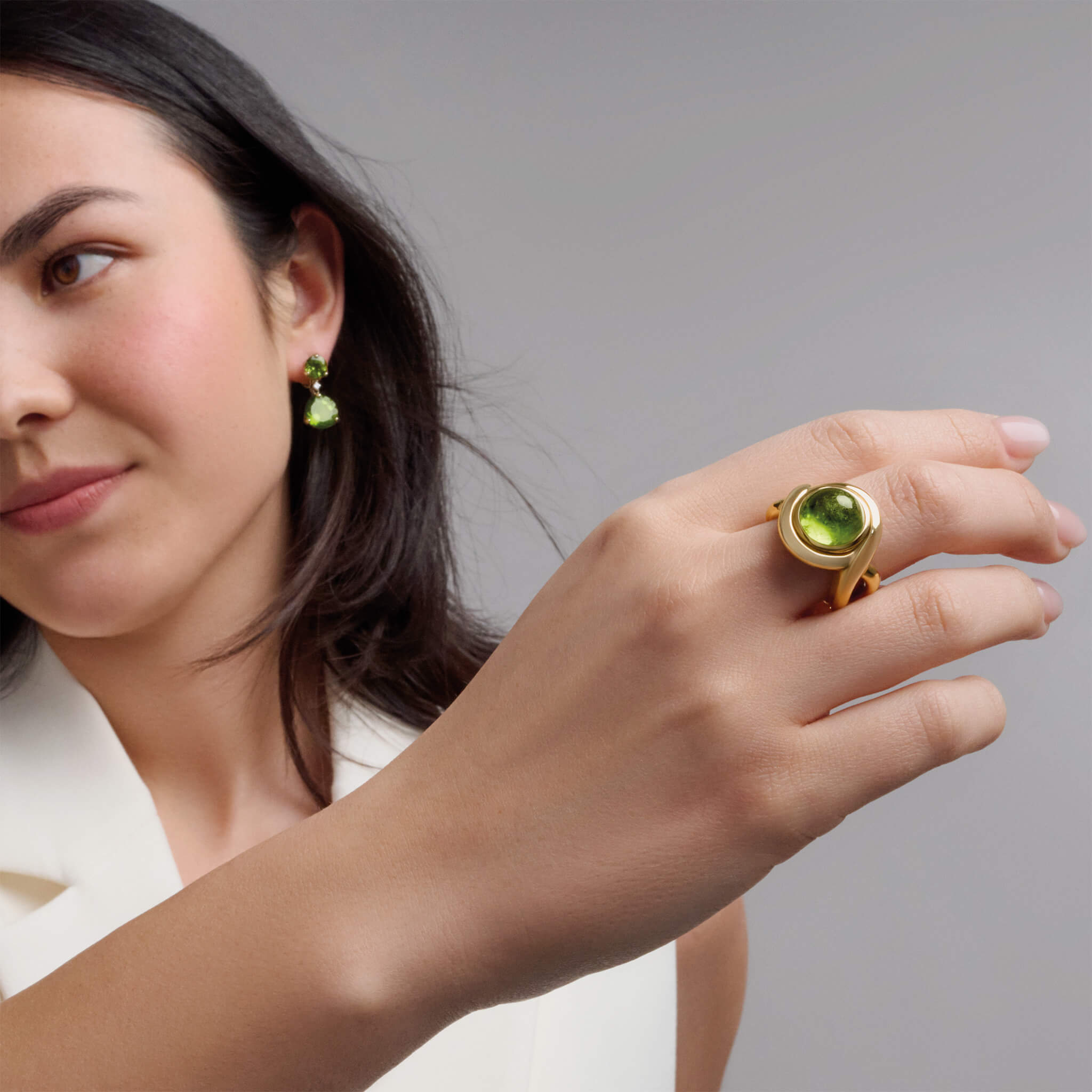 Handcrafted yellow gold ring featuring curved shanks with a cabochon peridot, birthstone of August.