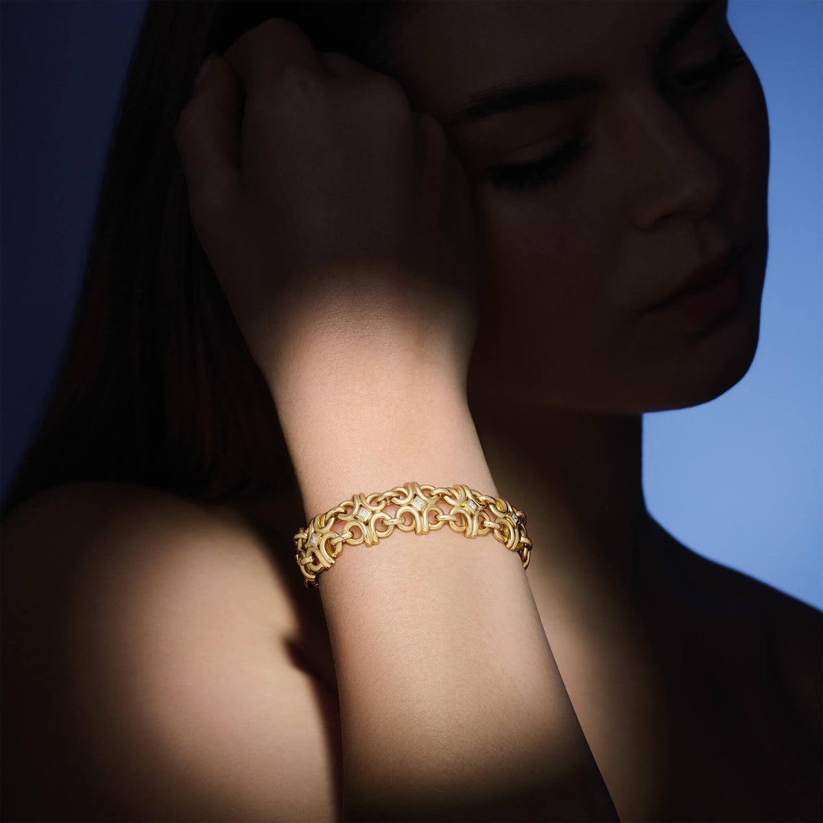 Model wearing handcrafted high jewellery Beatrice bracelet in yellow gold with diamond
