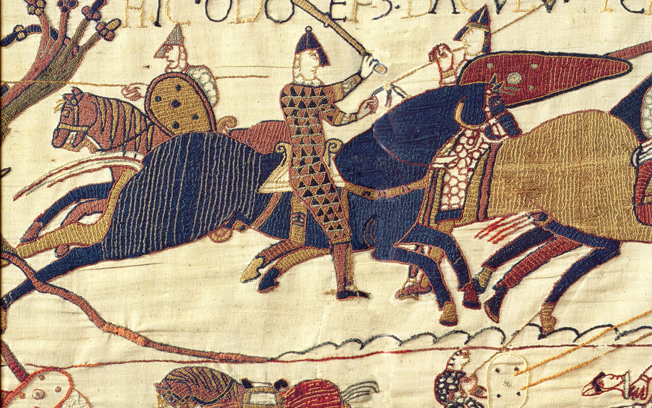 Embroidered scene from the Bayeux Tapestry with knights on horseback
