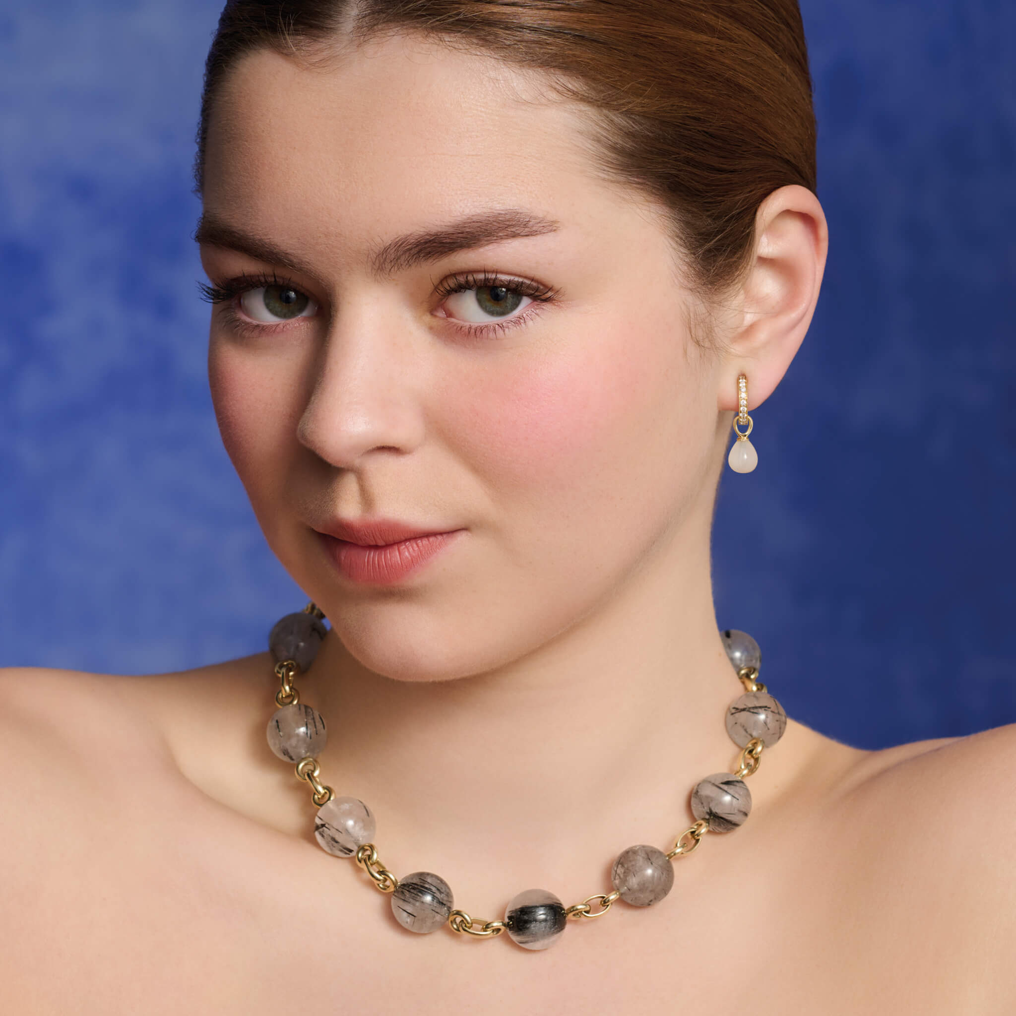 Model wears handcrafted 9ct yellow gold necklace with large black and white tourmalinated quartz beads.