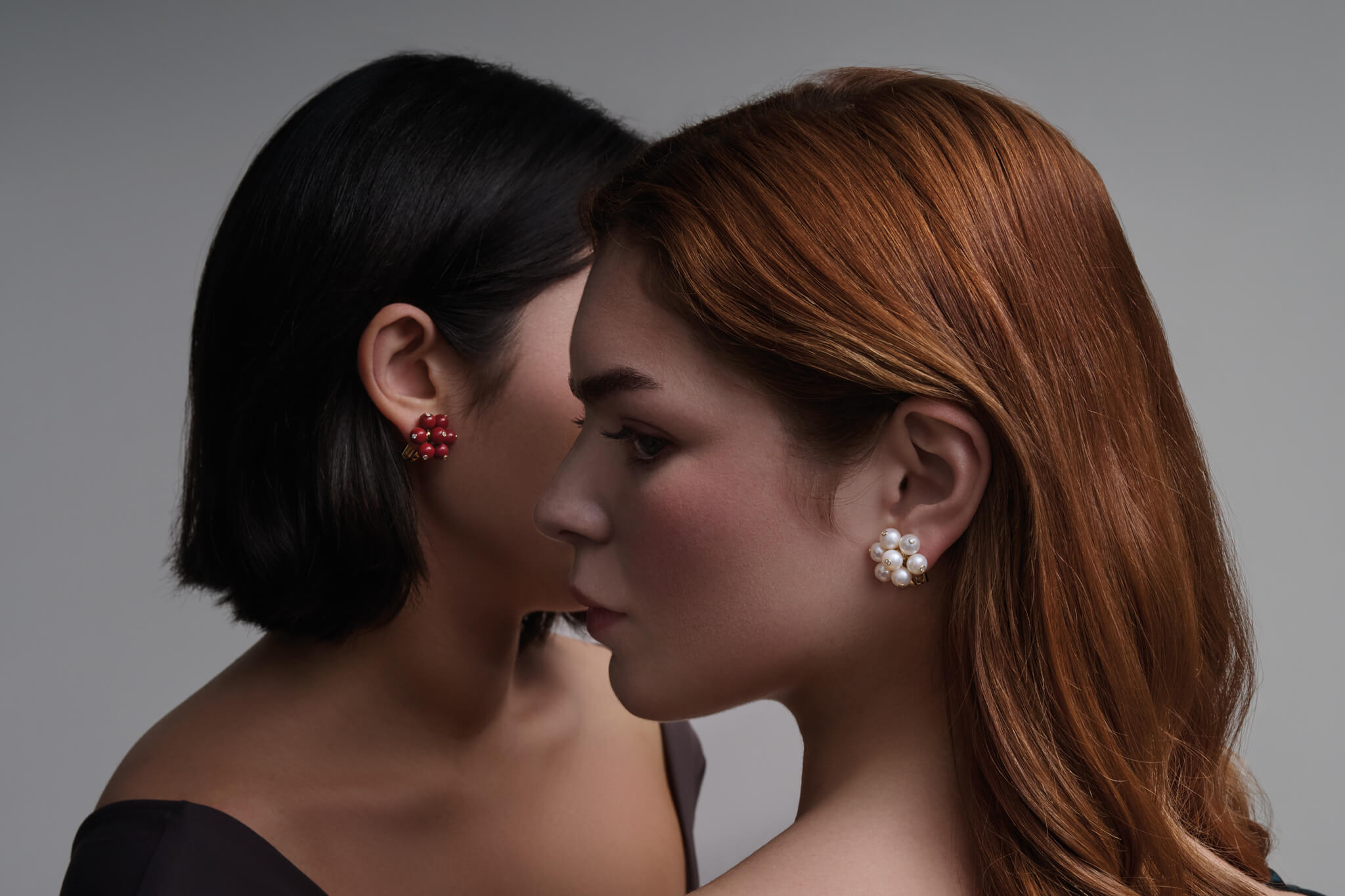 Models wears handcrafted Cavolfiore earrings with pearl, red coral and diamond.