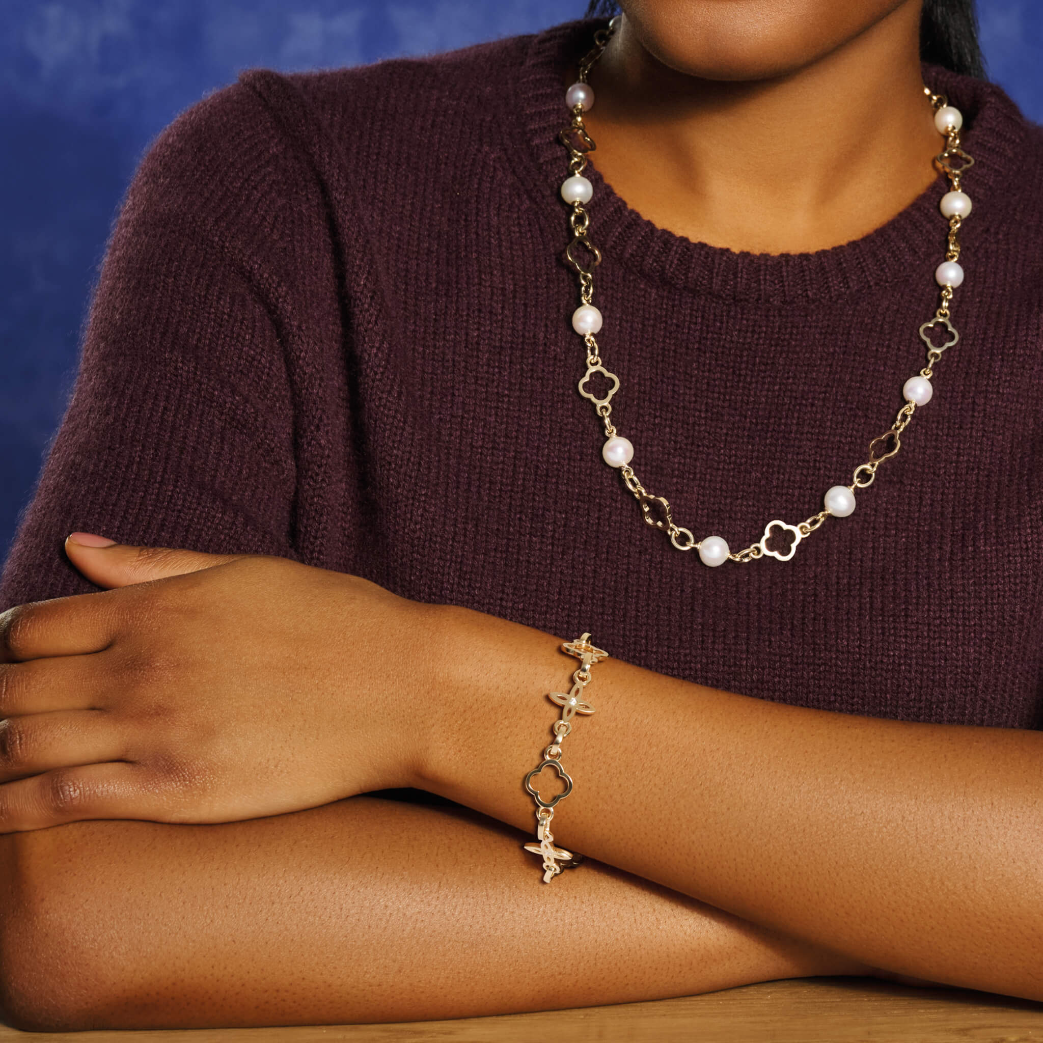 Model wearing a handcrafted 9ct yellow gold bracelet with star-shaped links and diamonds.