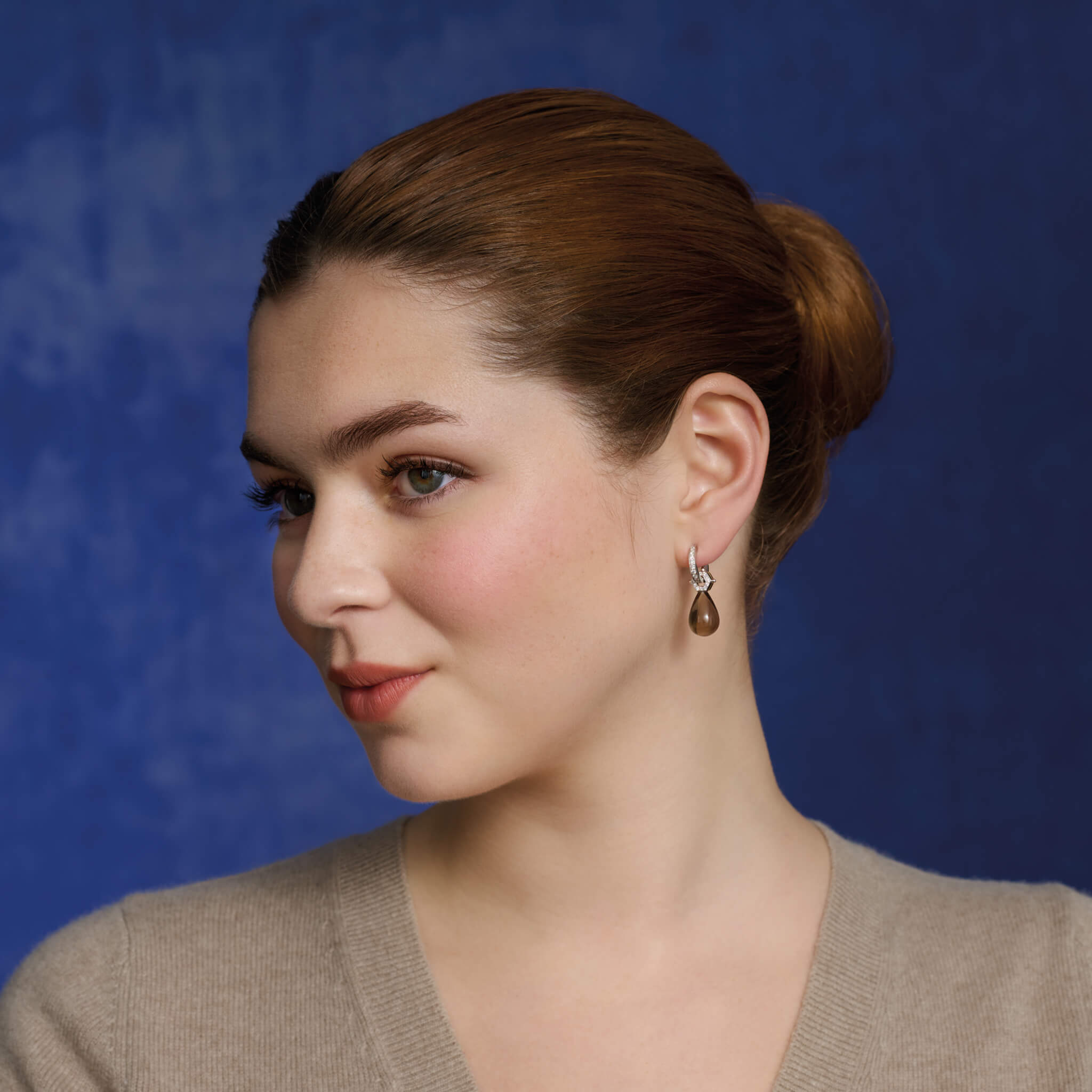 Model wears the Melissae di Erice earring drops in white and yellow gold with smoky quartz and diamond.