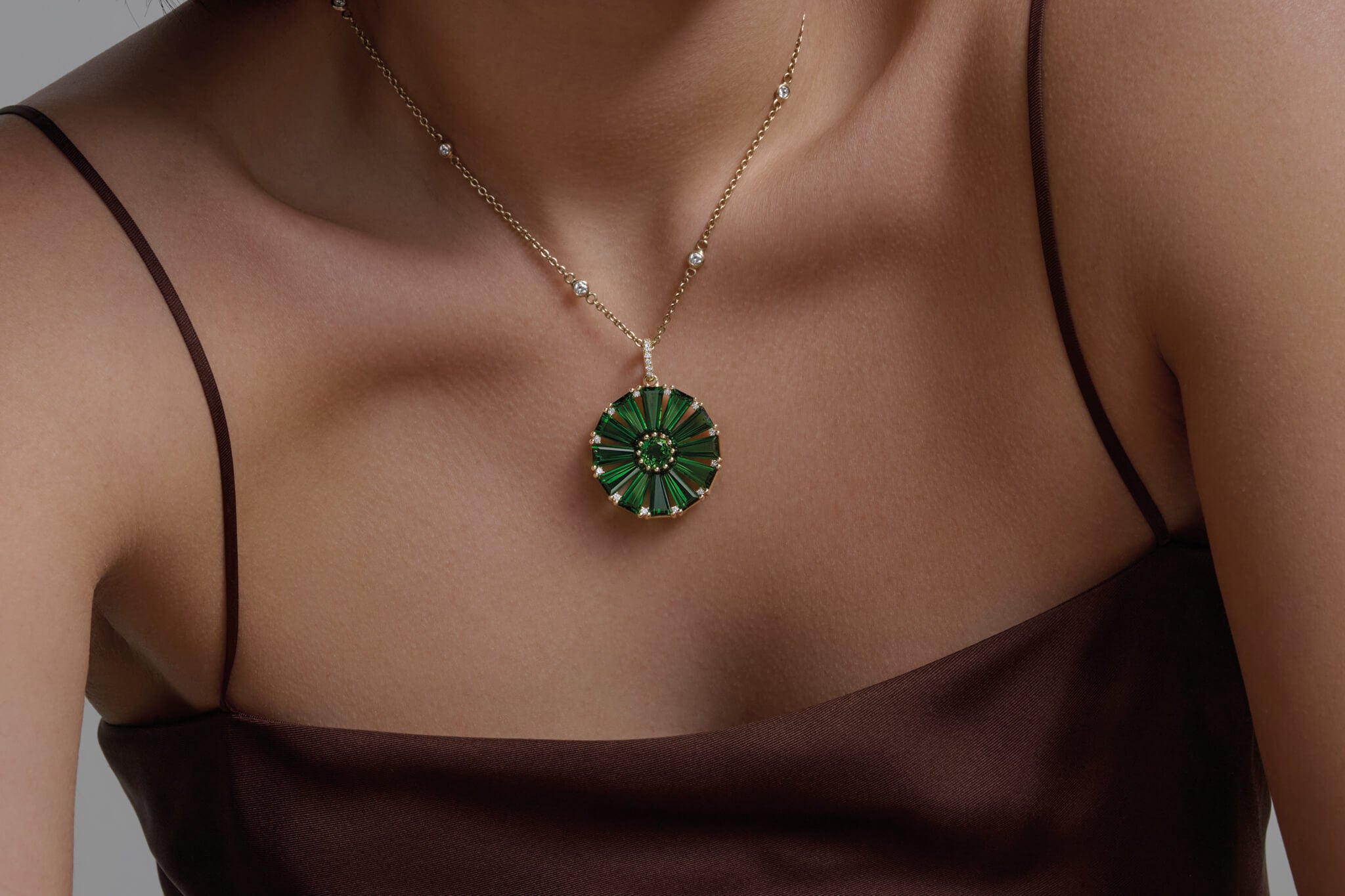 Model wears Roi Soleil pendant with rare chrome diopside and diamond.