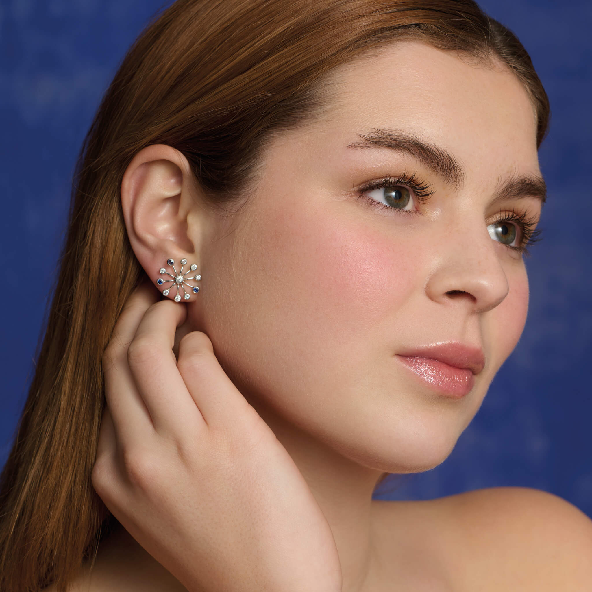 Handcrafted 18ct white gold earrings inspired by the delicate spurs of an astrantia flower, with sapphires, aquamarines and diamonds set at the tip of each spur.