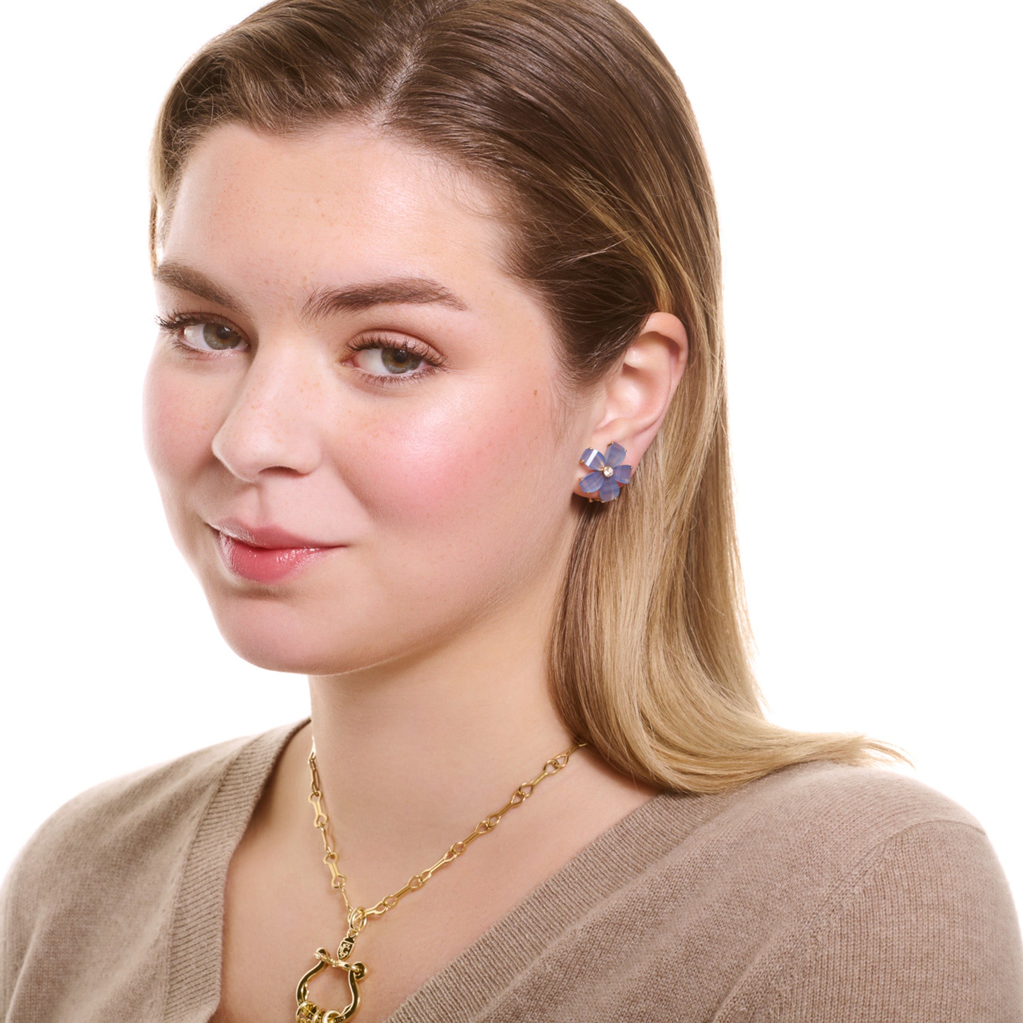Model wearing handcrafted yellow gold flower earring studs featuring five blue chalcedony petals and a central diamond.