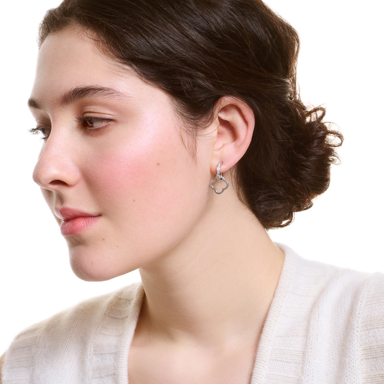 Model wearing handcrafted sterling silver star shaped earring drops.