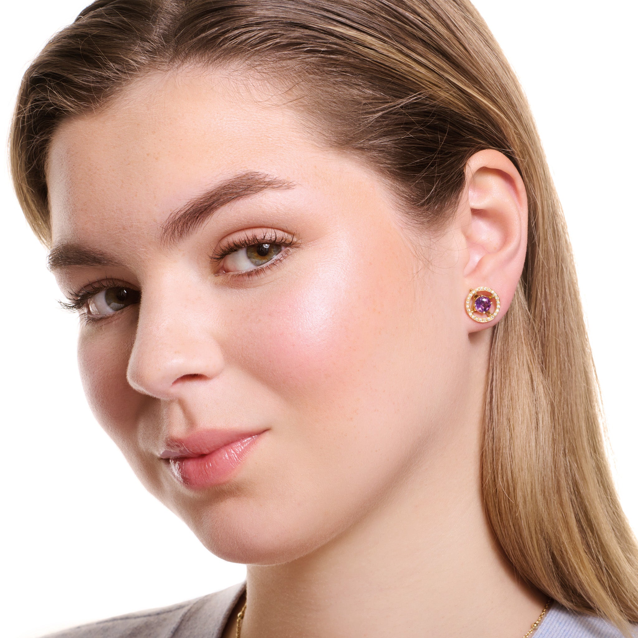 Model wearing handcrafted 18ct yellow gold earring halos featuring a circular shape with diamonds.