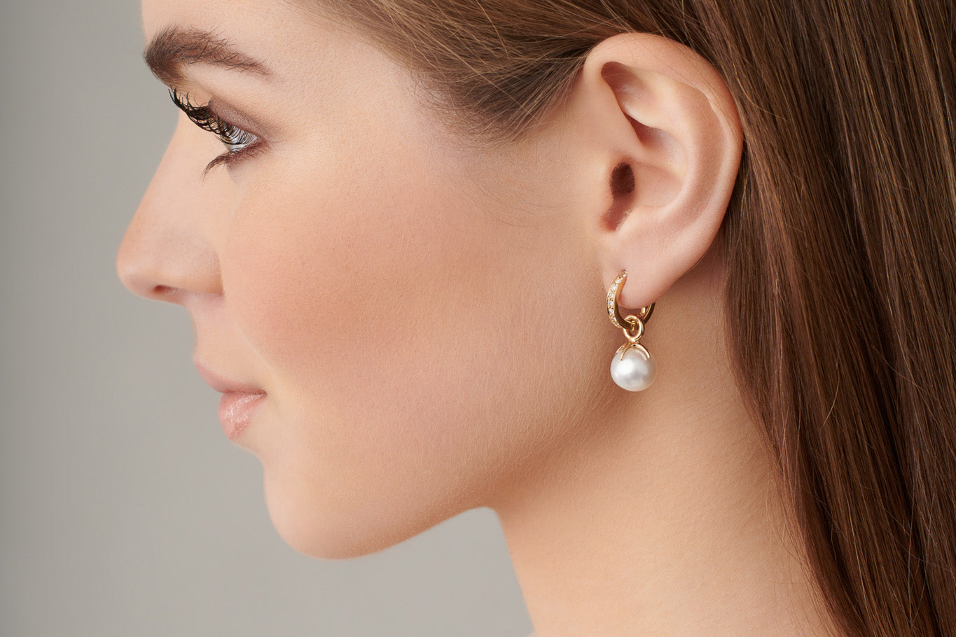 Model wearing handcrafted gold earring drops featuring the Tamara design.