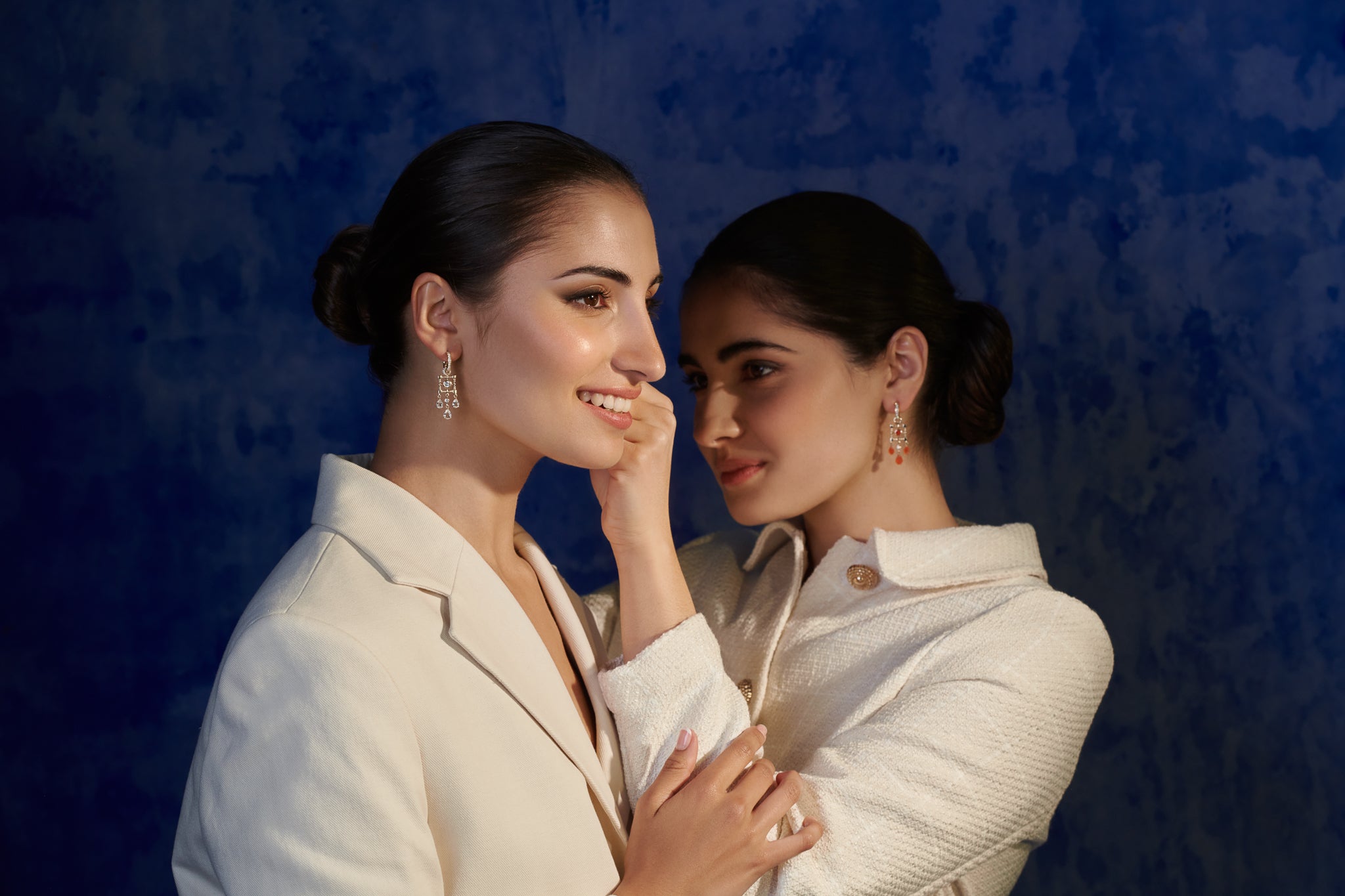 Models wearing handcrafted gold jewellery with precious gemstones, inspired by Morocco.
