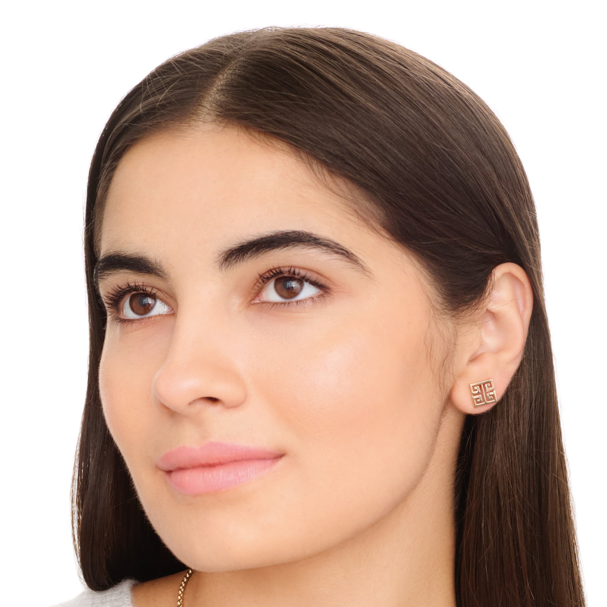 Model wearing handcrafted 9ct yellow gold square stud earring with iconic symmetrical Greek motif.