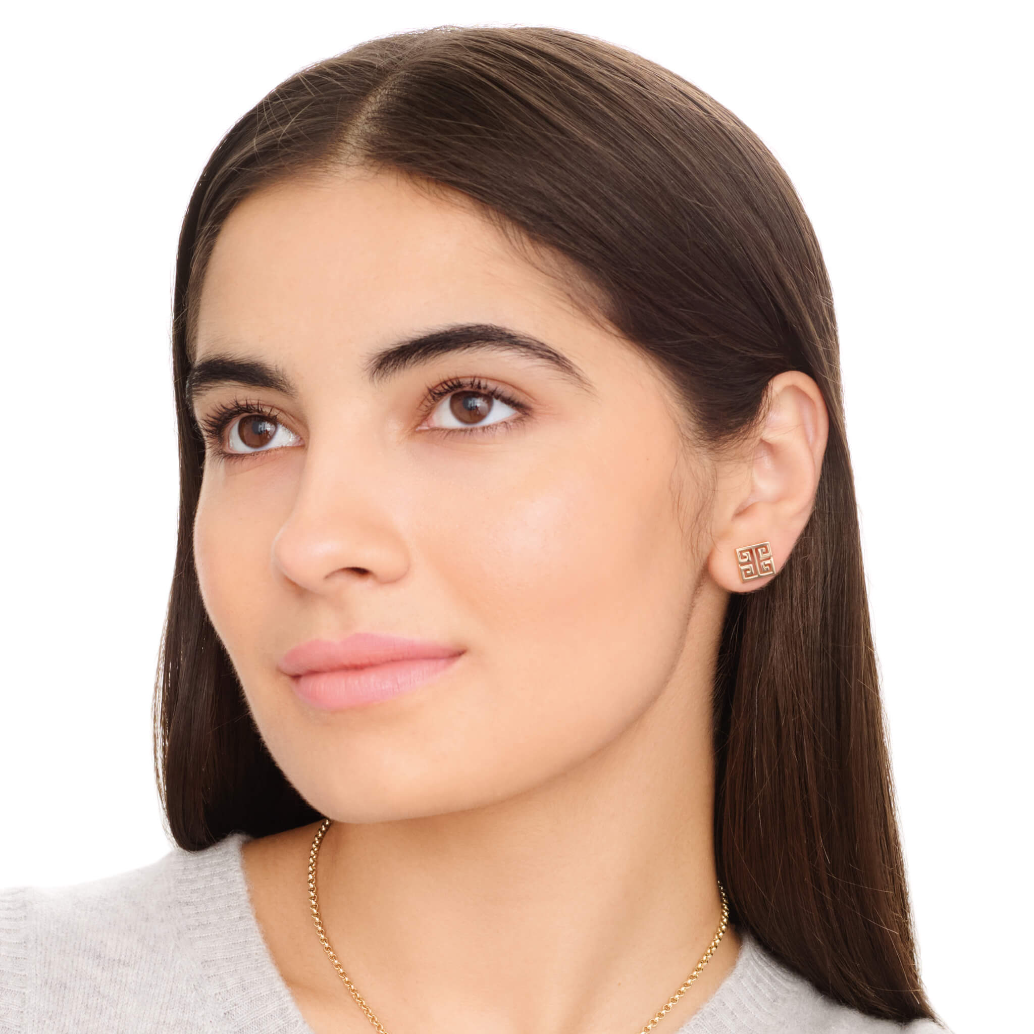 Model wearing handcrafted square stud earrings with iconic symmetrical Greek motif.