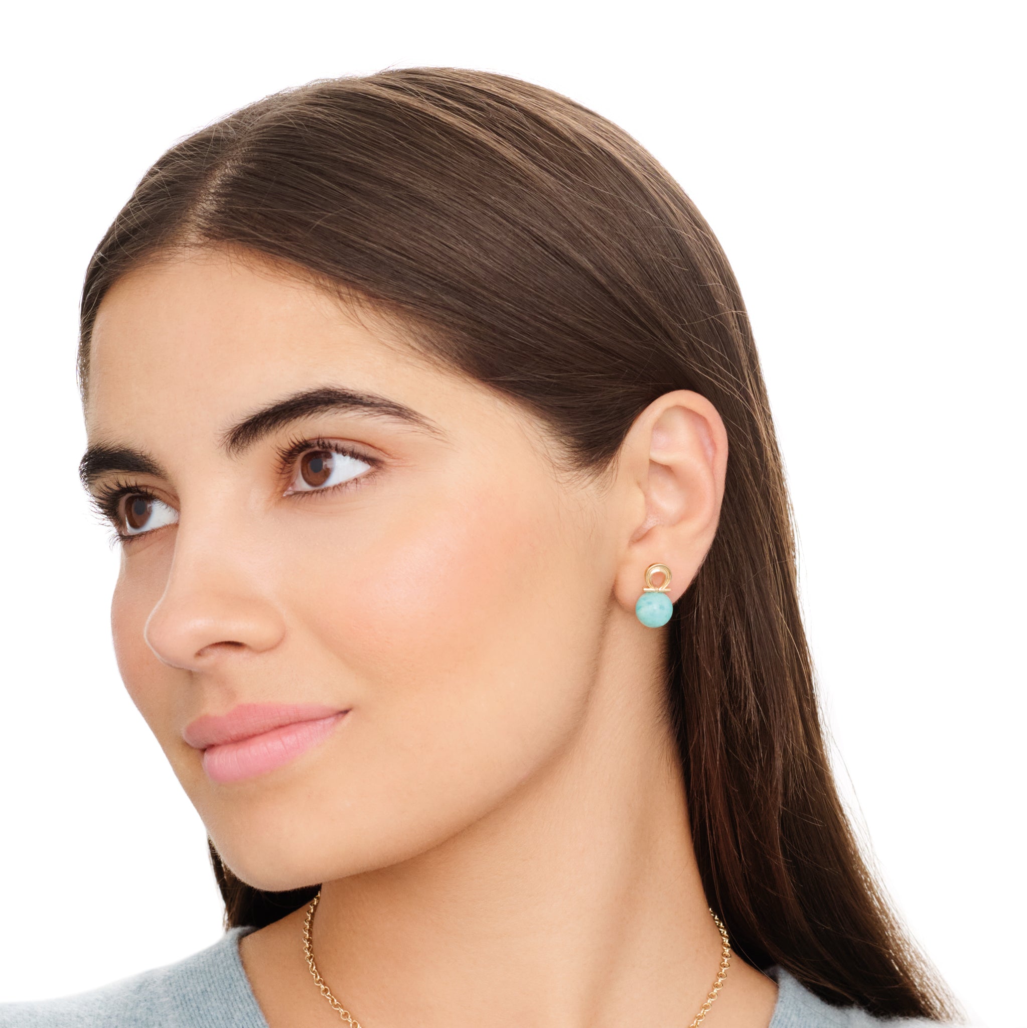 Model wearing handcrafted 9ct yellow gold omega Greek letter shaped stud with blue amazonite bead.