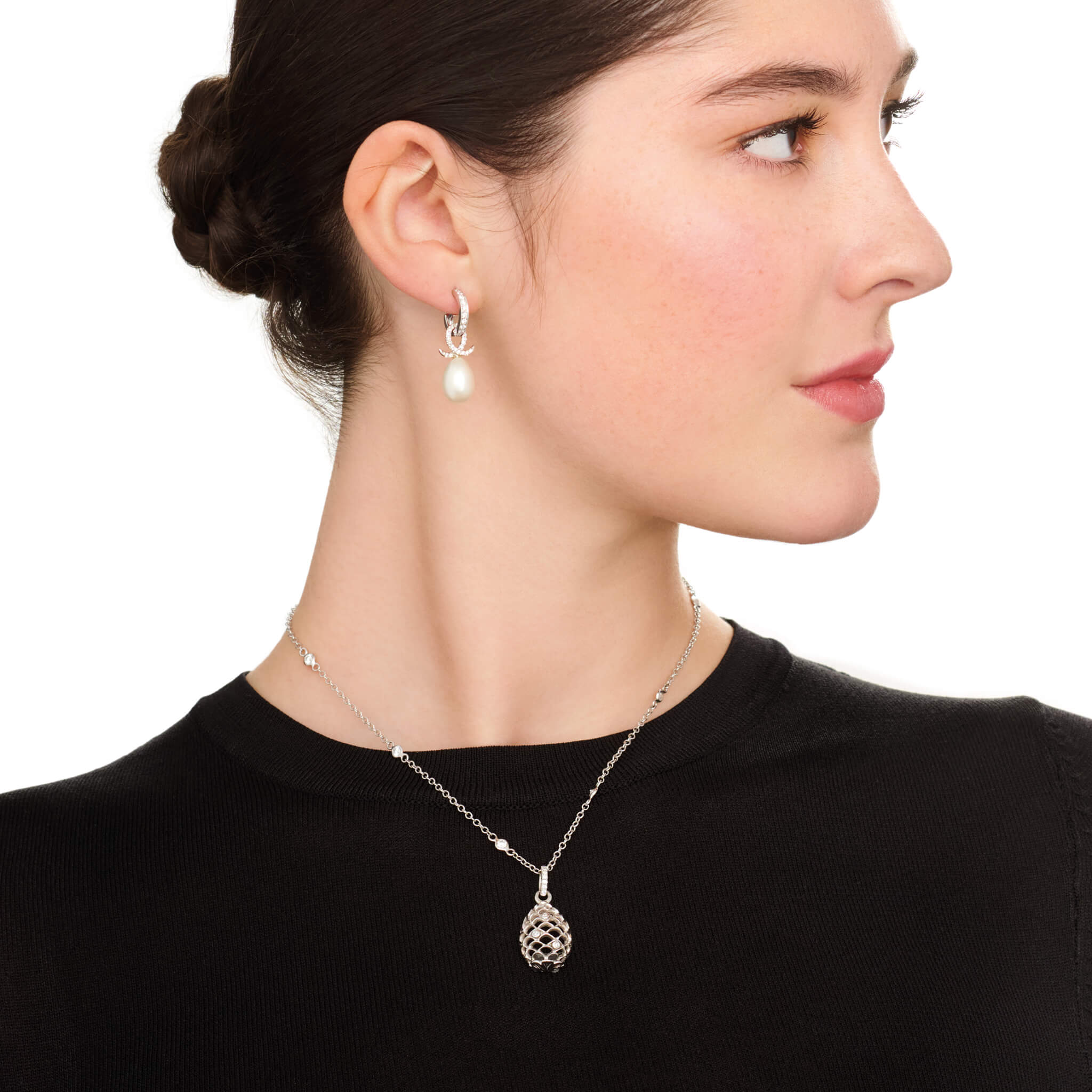 Handcrafted precious metal necklace pendant featuring a pinecone frame with precious stones.