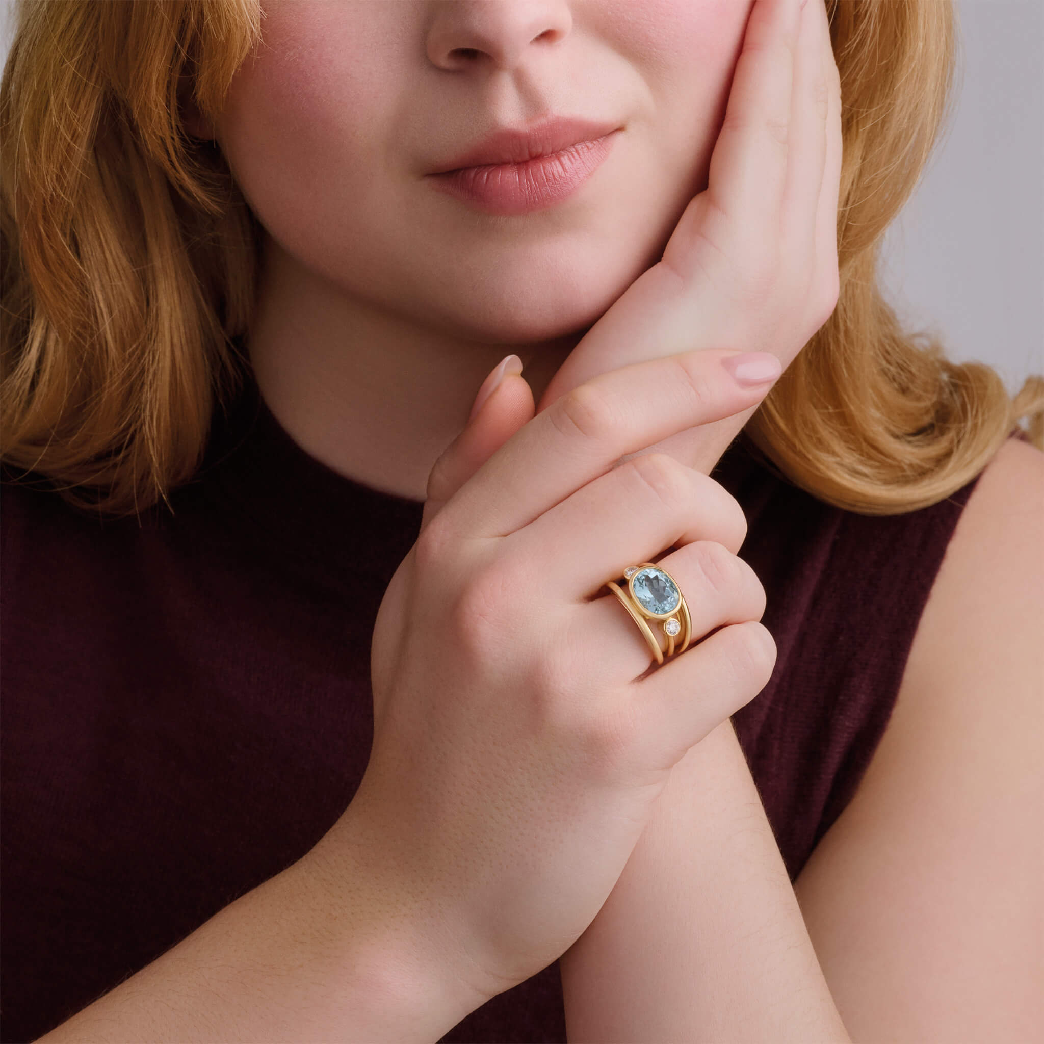 Handcrafted 18ct yellow gold ring with a central aquamarine, the birthstone of March, flanked by two round diamonds.