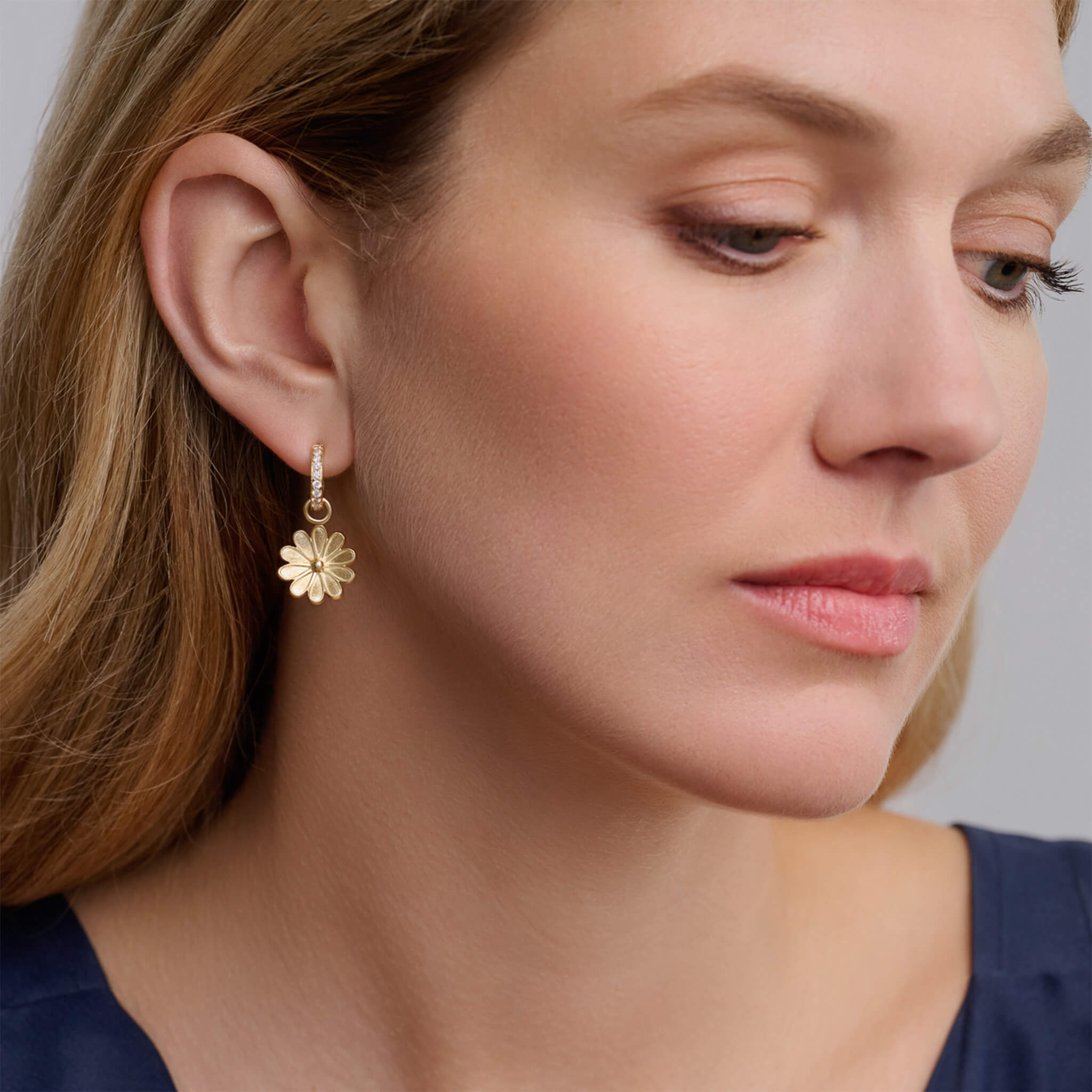 Handcrafted 9ct yellow gold earring drops in the shape of an anemone flower on yellow gold hoops.