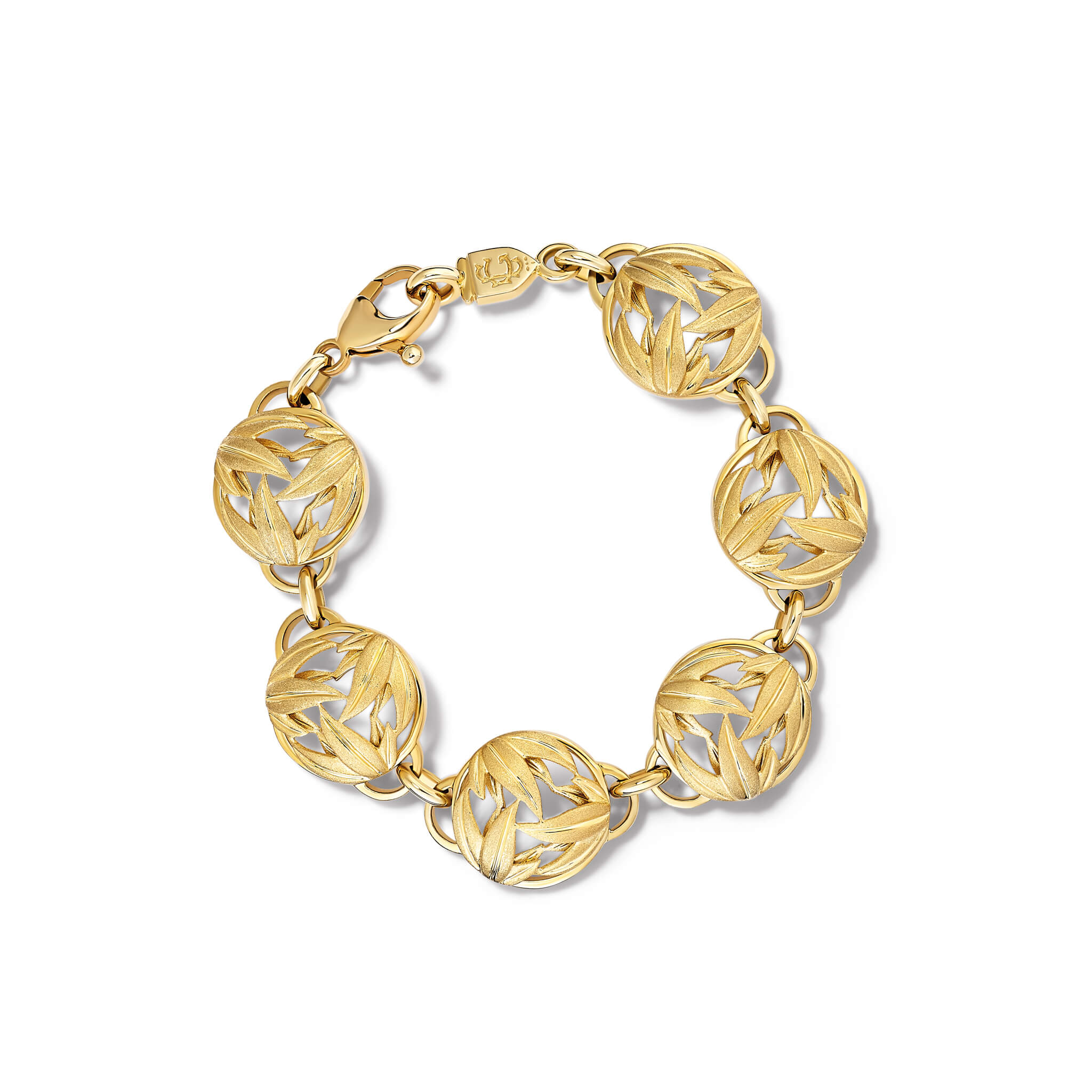 Handcrafted yellow gold bracelet with circular sculpted links featuring a brushed leaf motif