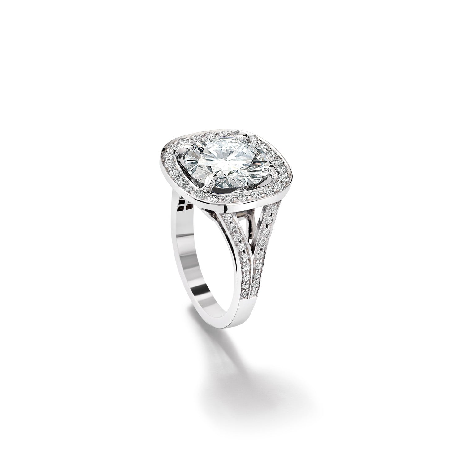 An 18ct white gold engagement ring featuring a central diamond surrounded by a pavé diamond halo.