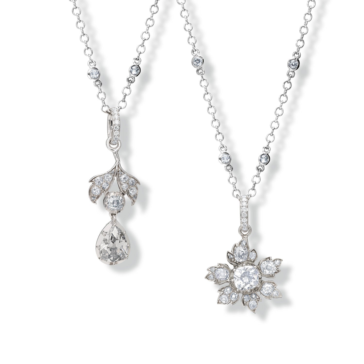 Two 18ct white gold necklace pendants, each repurposed from a vintage brooch and set with sparkling diamonds.
