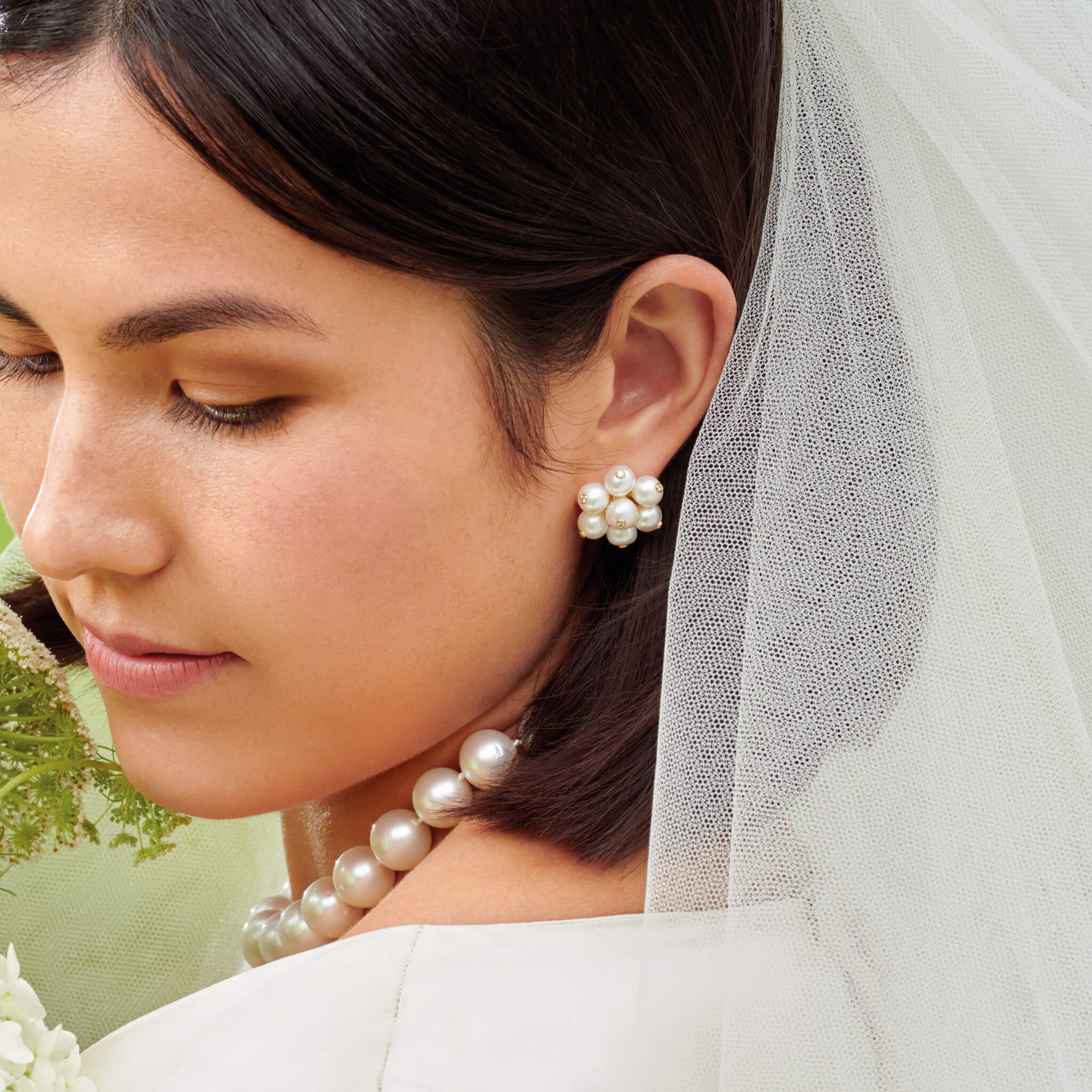 Bride wears handcrafted 18ct yellow gold, pearl and diamond earrings on her wedding day. Discover gifts for the wedding day.