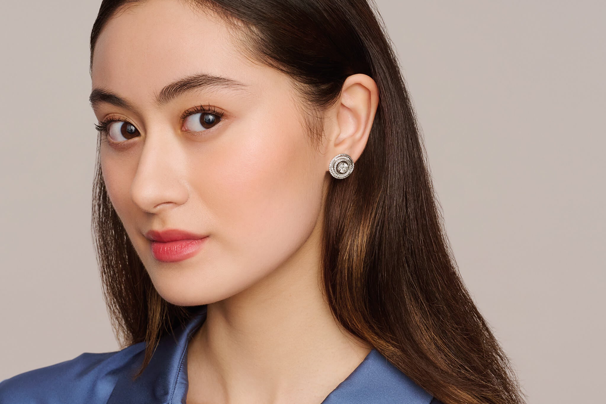 Model wearing diamond studs which is the birthstone of April.