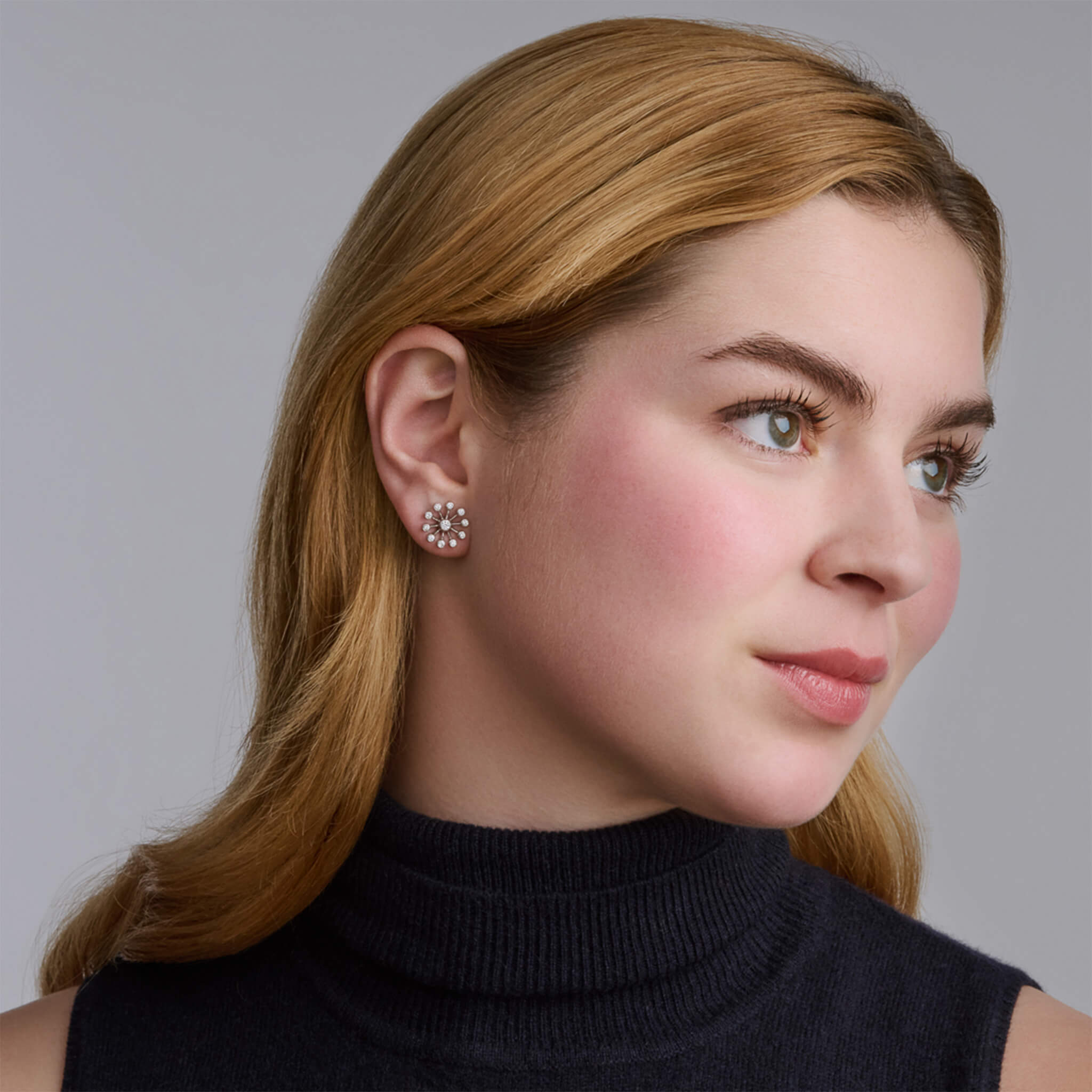 Handcrafted 18ct white gold earrings inspired by the delicate spurs of an astrantia flower, with diamonds set at the tip of each spur.