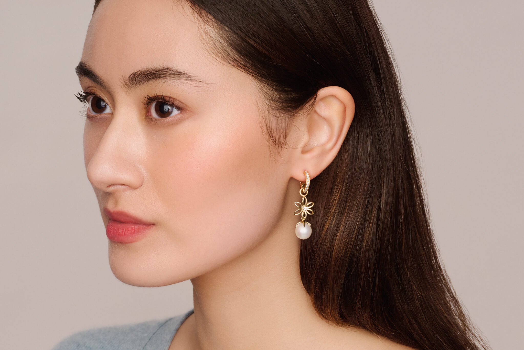 Model wearing Fleur de Lys earring drops