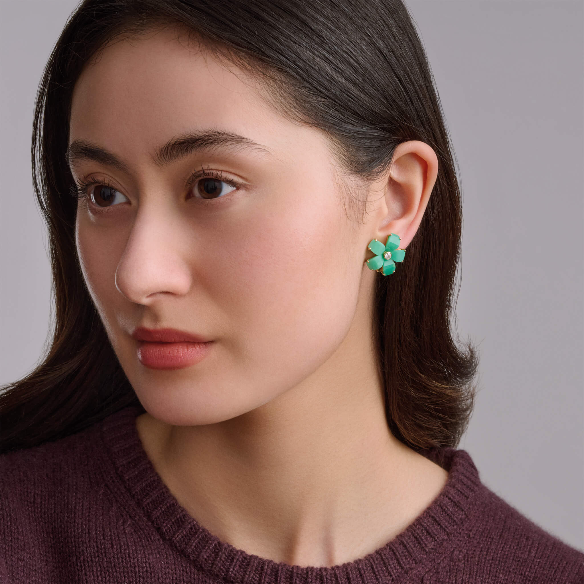 Model wearing chrysoprase frangipani stud earrings.