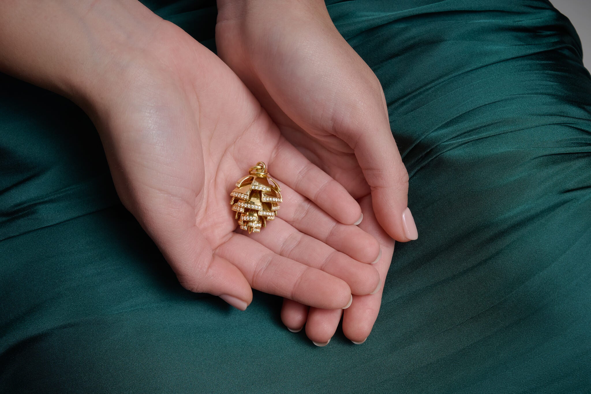 Model holds the Furu Kongle necklace pendant