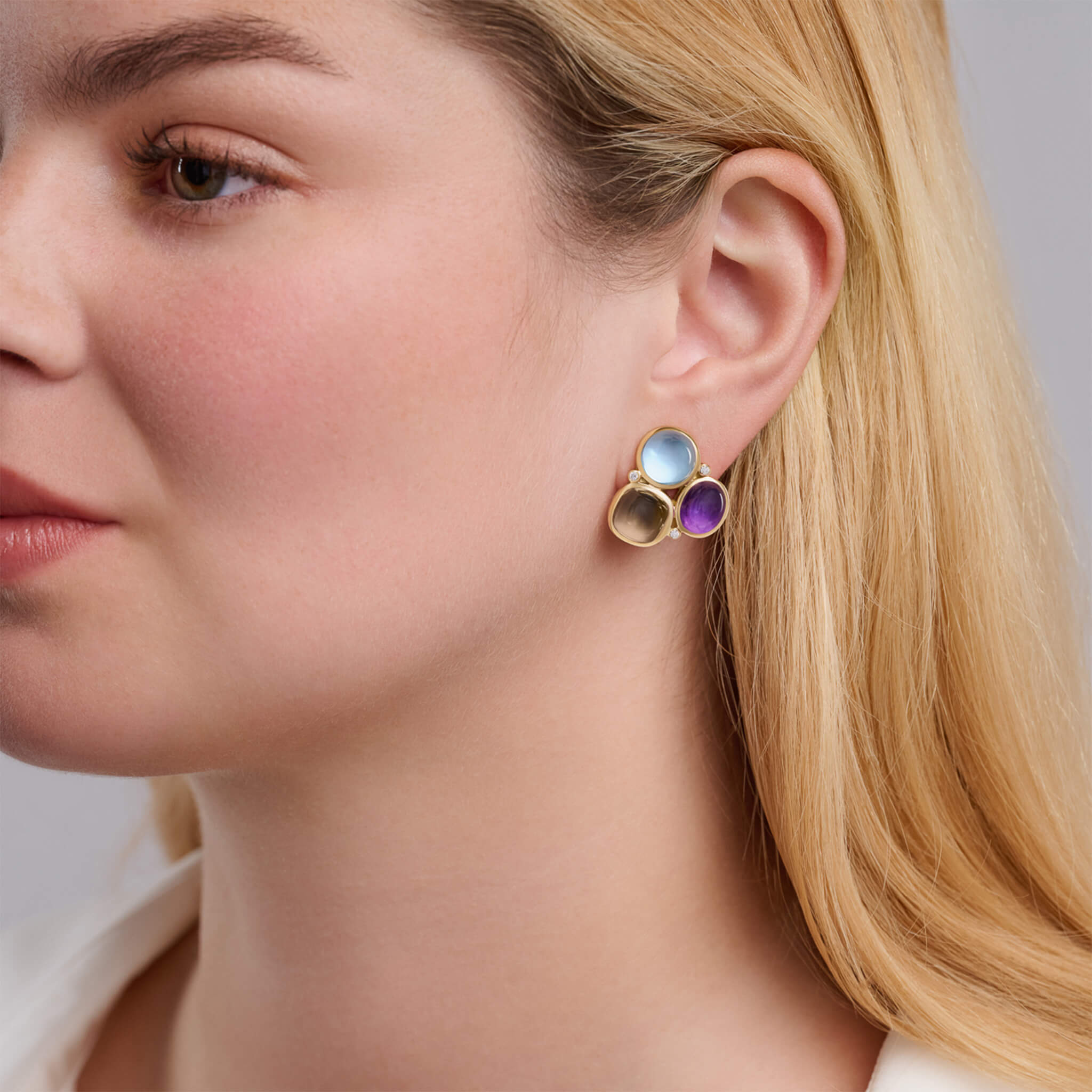 Handcrafted fuscata earrings in 18ct yellow gold with cabochon amethyst, smoky quartz, blue topaz and diamond are inspired by the Japanese Heraldic crest