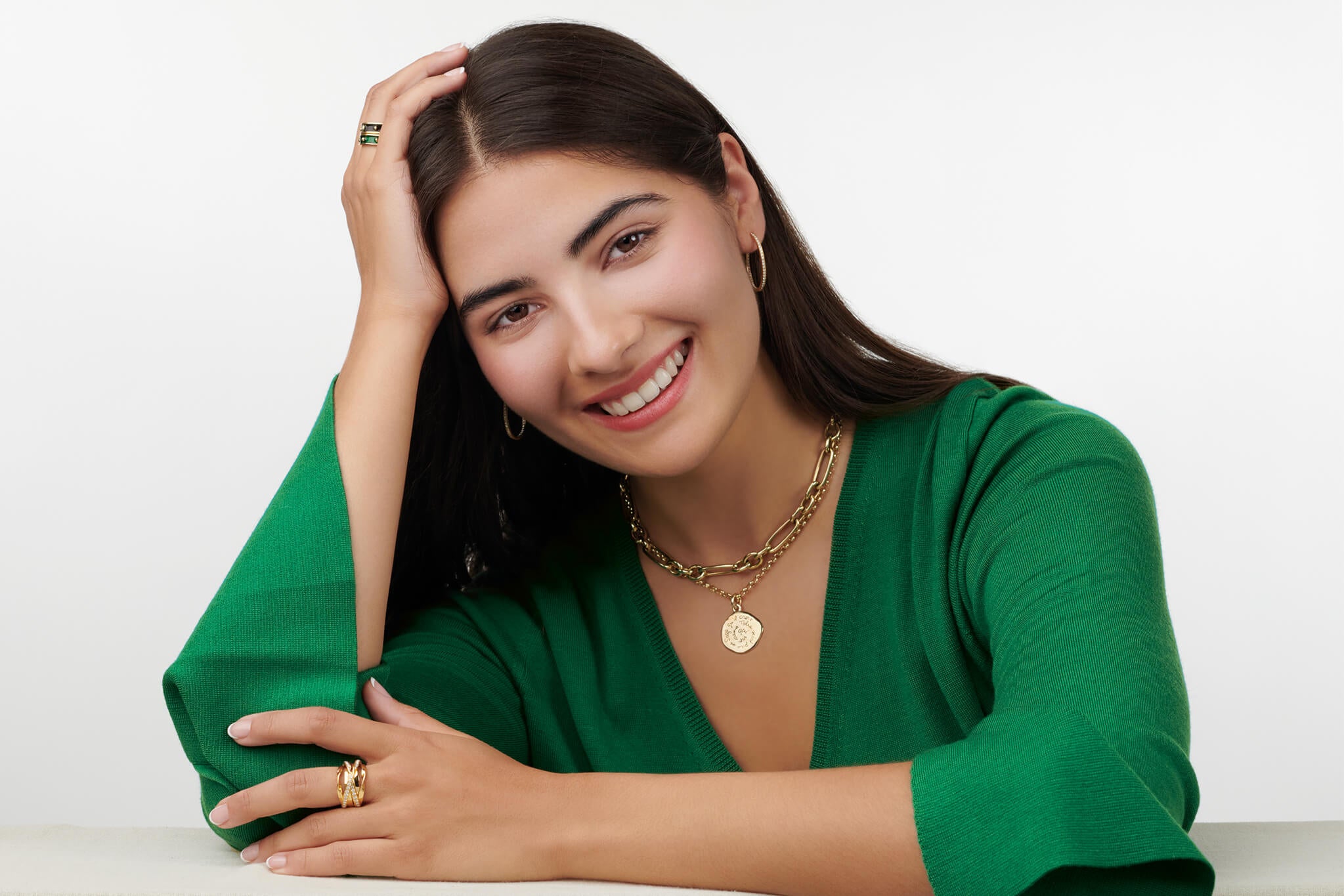 Model wearing handcrafted yellow gold jewellery perfect for graduation, with personalisation available.