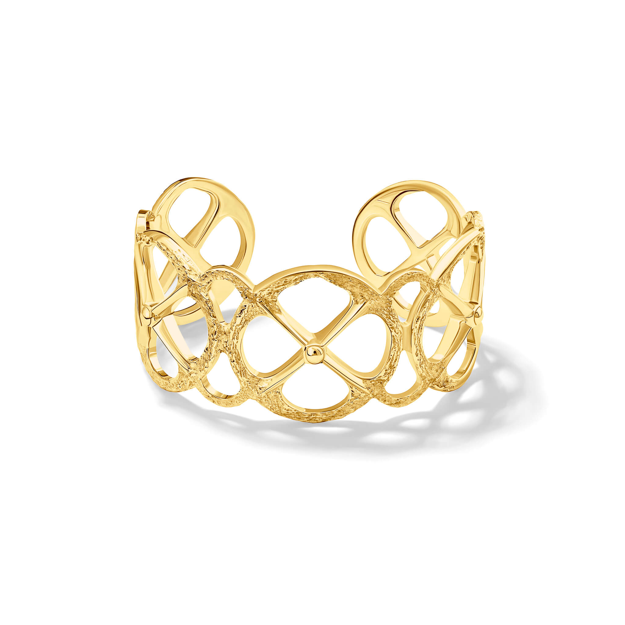 Handcrafted yellow gold cuff bracelet with a circular motif and a cross in the middle.