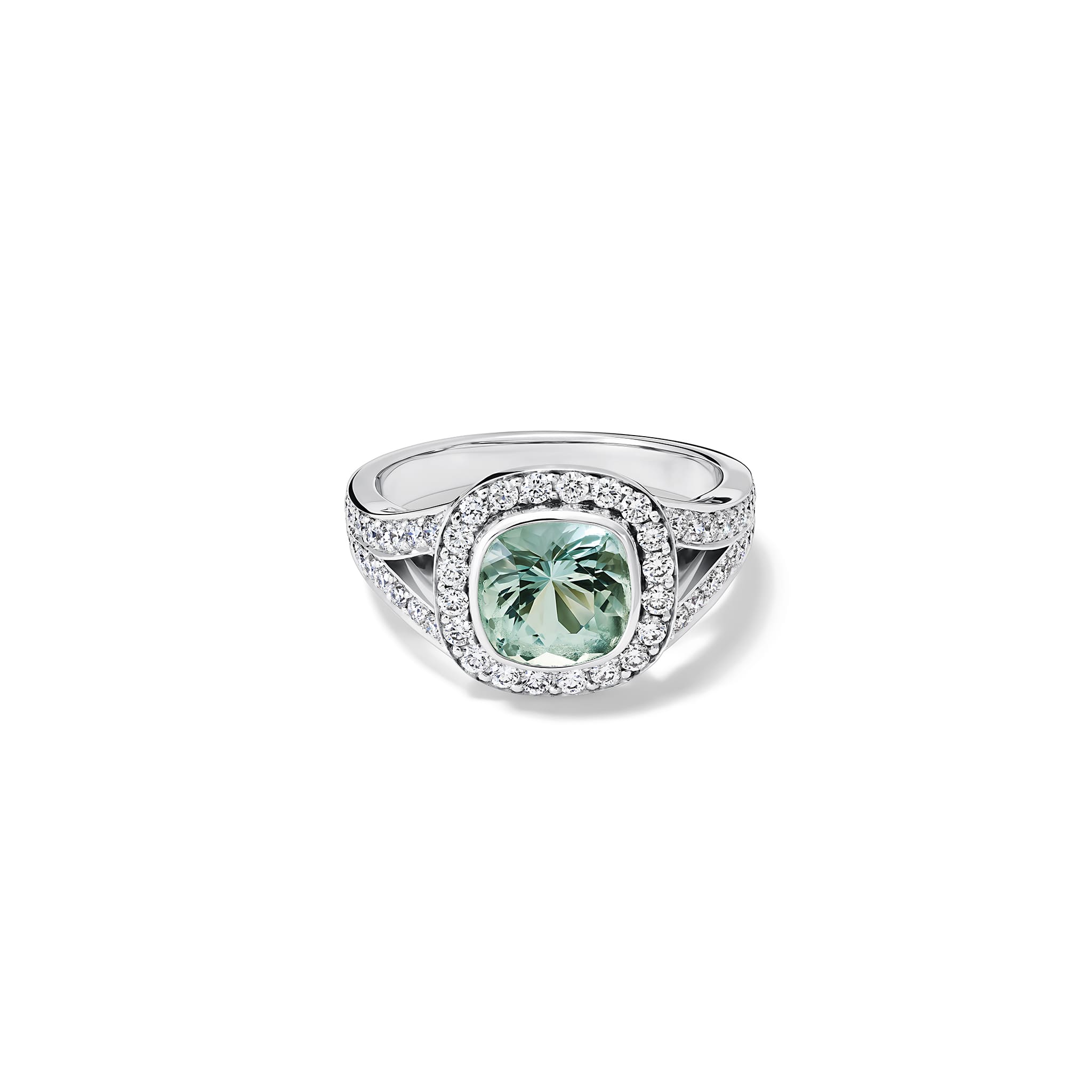 Handcrafted 18ct white gold engagement ring featuring a large, cushion-cut green aquamarine surrounded by a halo of small diamonds and smaller diamonds embedded along the band, March birthstone