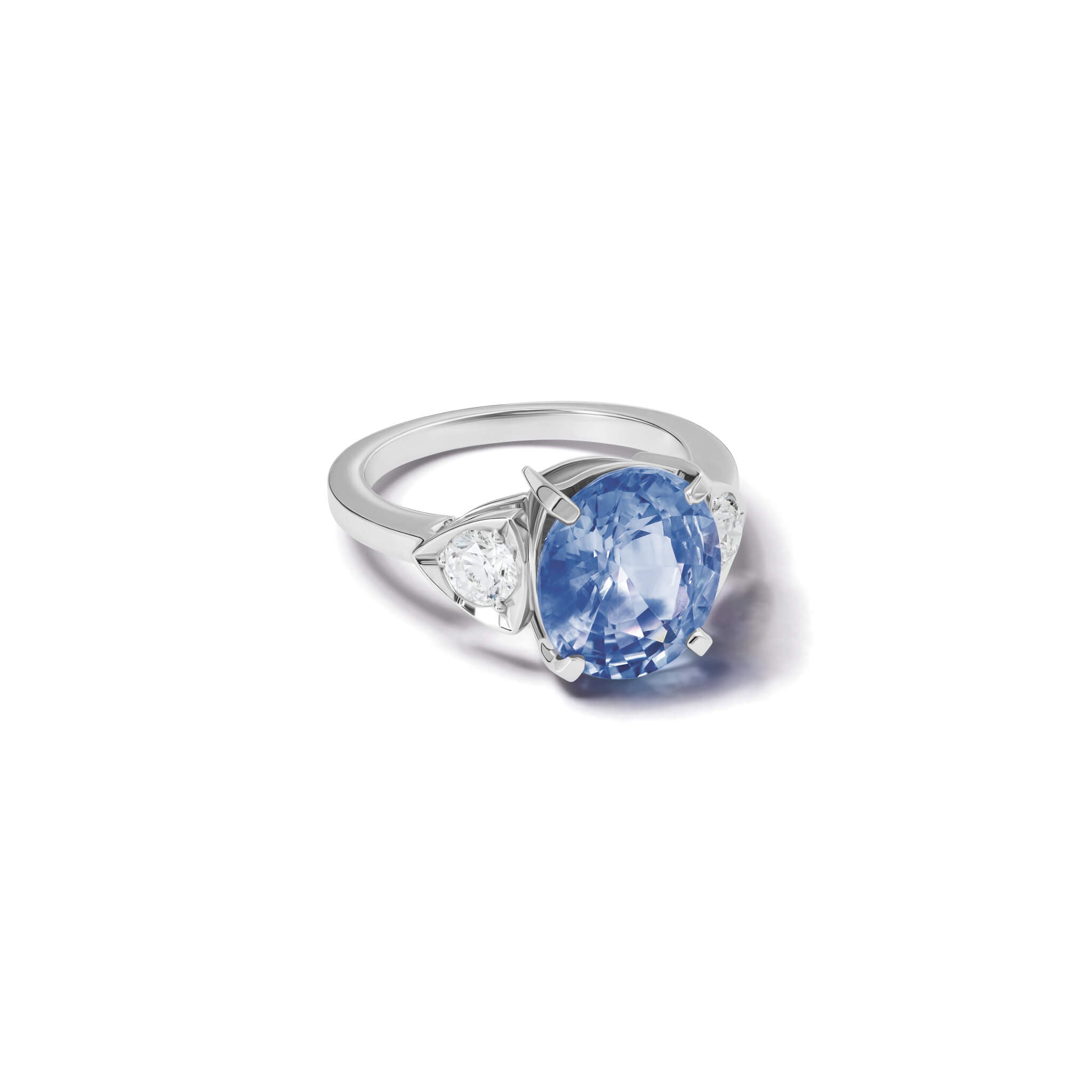 Handcrafted 18ct white gold engagement ring featuring a large central oval sapphire flanked by one smaller teardrop-shaped diamond on each side.