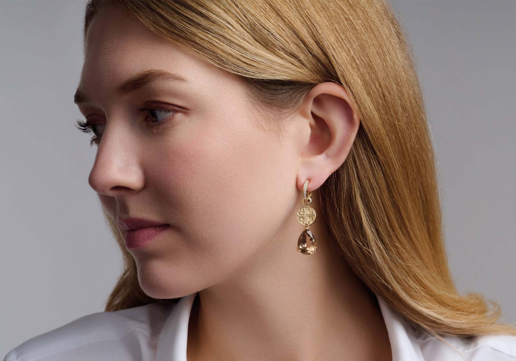 model wearing handcrafted yellow gold drops called Kefalonia