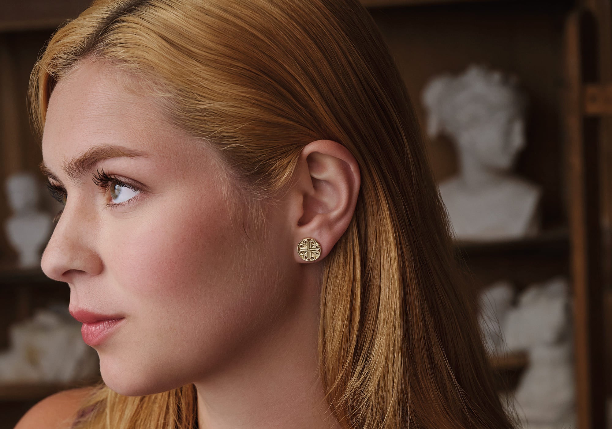Model wears handcrafted yellow gold earrings from Kefalonia design