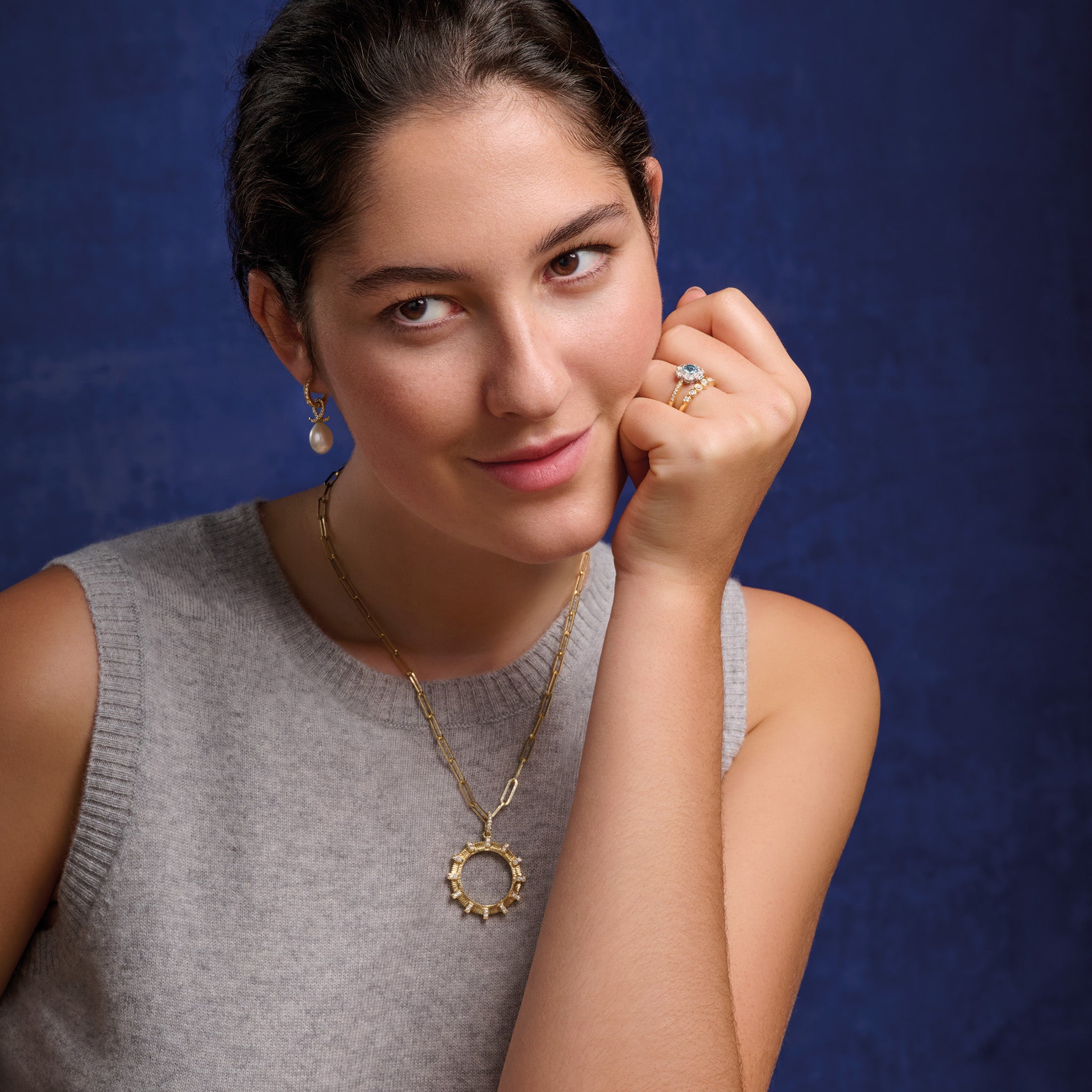 Model wears the handcrafted Kipoi necklace pendant in yellow gold with diamond pav�. Inspired by the stone bridges of Zagori in northern Greece.