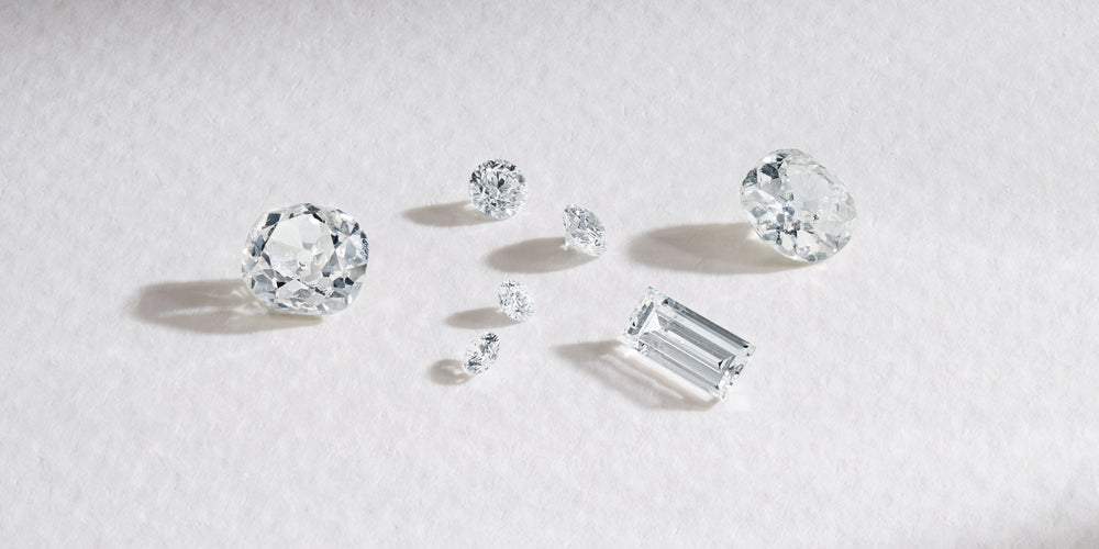 Loose diamonds in different cuts on white background