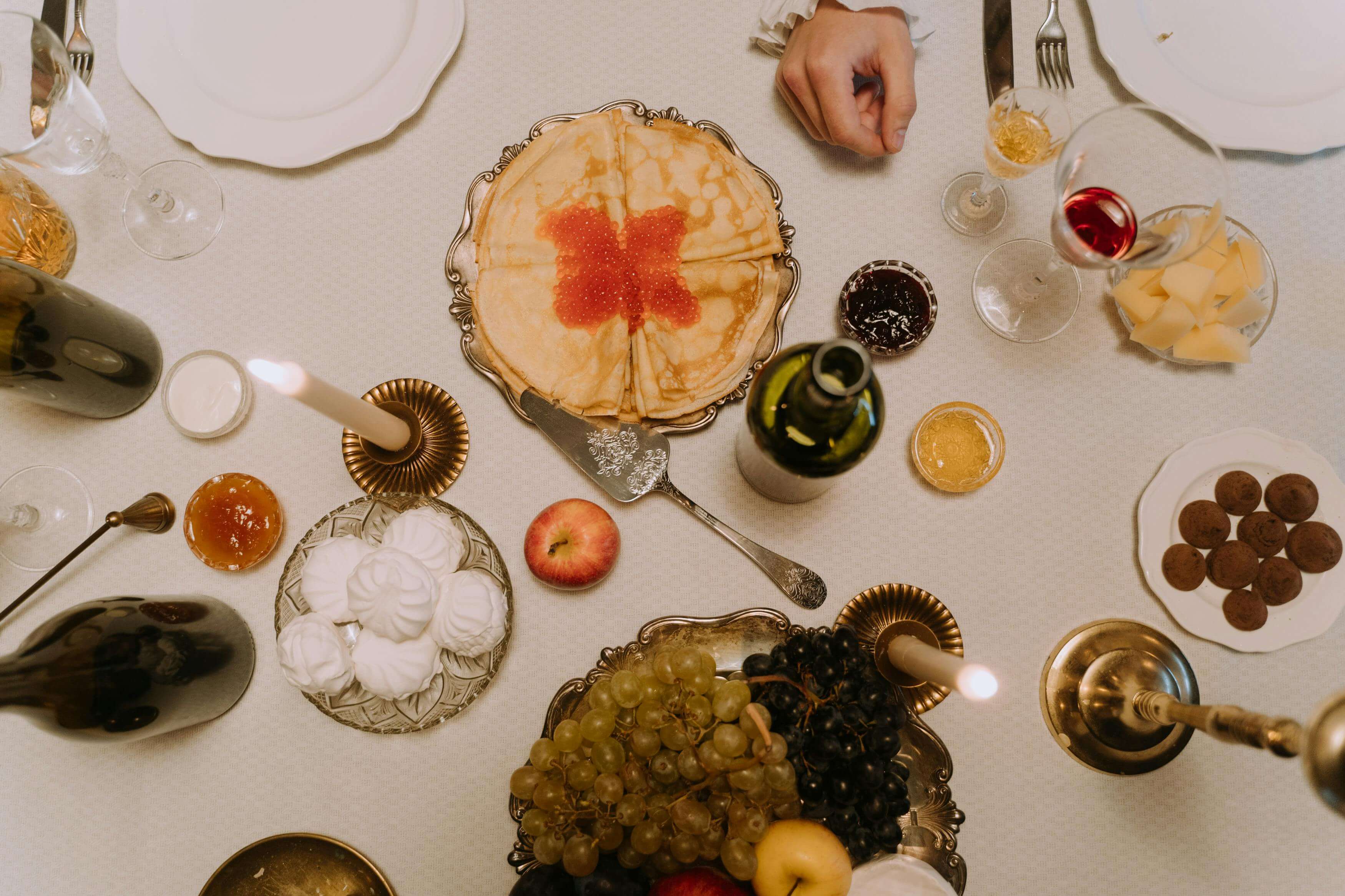 Birdseye view photo of luxury dinner table with caviar and wine.
